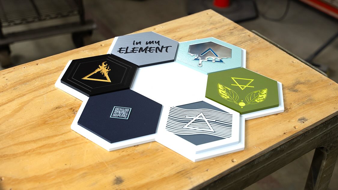 The Index Plaque!
I created this plaque as an index to guide the “In My Element” plaque collection, developed in collaboration with Gemini. It features small plaques that mirror elements from their corresponding main plaques. To make it interactive, I included a QR code that links to an article I wrote detailing the entire design process.
For me, designing with intention is always the first step. One of the key intentions behind this piece is to blend materials and dimensions, while also extending its presence from the physical world into the digital realm. After all, like plaques in the real world, what you share online can live on forever. 😉
#plaquedesign #customsigns #design #metalsignage