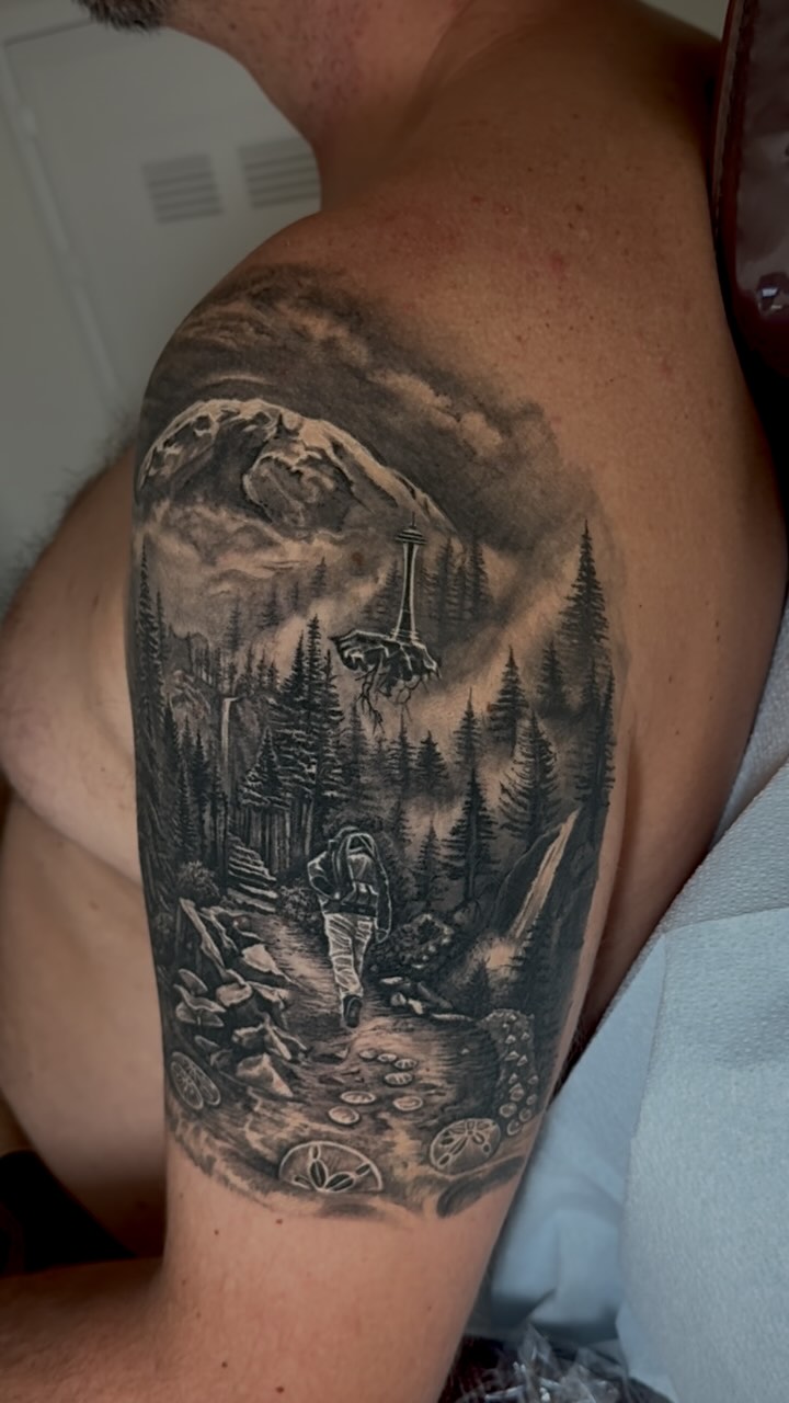 Details that won't go away! 😎
.
✨Happy 2025✨
.
Thank you, Ryan. I'm so happy with the results of this tattoo, and I'm even happier that I got to spend all these hours with you. 😊
.
Here is the piece we created with Ryan. We wanted to tell and represent so much that the best way I could think about it was to make it a whole landscape where we could transit through this experience together.🌄
.
We wanted to connect with emotions and meanings that I think we all hold with deep care in our hearts, and for Ryan, we were able to represent them on this awesome tattoo.
.
The feeling of getting in touch with your happy place through the self-knowledge and out exploring. The sense of gratuity for what fate has brought to our lives and the resilience to accept what it has taken away from us. The love for home and the deep connection we can find with our surroundings and within them… thank you, Ryan, for making me part of this tattoo and giving me the trust needed to make it happen.
.
⚠️Information about the tattoo
At this point, the tattoo is fully healed, and we started it almost two years ago,
As you guys can see, the details of the video are solid and won't need any touch-up in the future.
White ink was used only for highlights; the rest of the tattoo is grey wash / black ink only.
#seattle #seattlelife #spaceneedle #2025 #details #newyear #washingtonstate #blackandgreytattoo