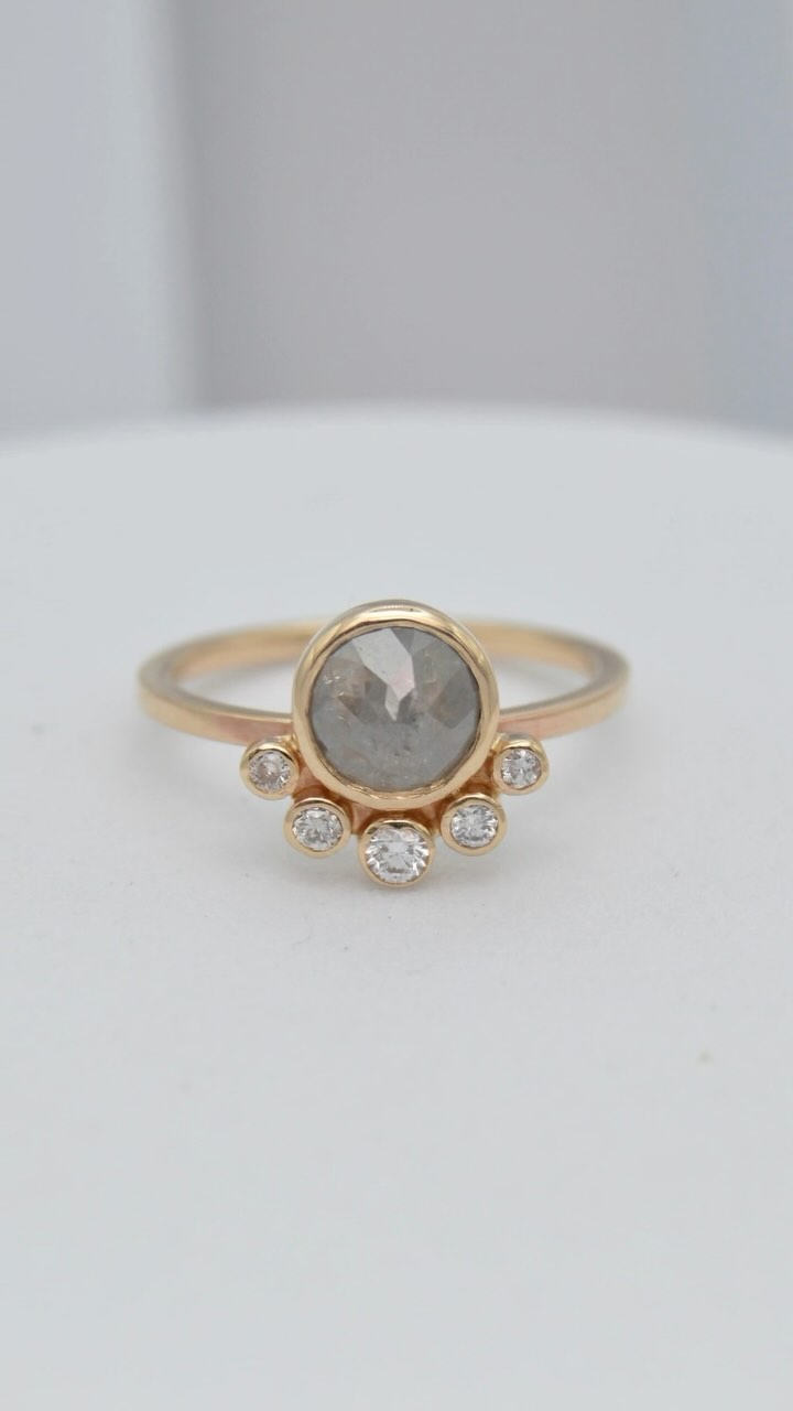 Watch as this custom engagement ring comes to life! Featuring a mesmerizing salt and pepper rose cut diamond, accented with five brilliant diamonds, all set in 14k gold. Crafted with care just before the holidays! 💍 #handcraftedjewelry #saltandpepperdiamond #customengagementring #finejewelry #madewithlove #portlandmainejeweler #jewelrydesign #uniqueengagementring #goldjewelry #engagementring #diamondjewelry