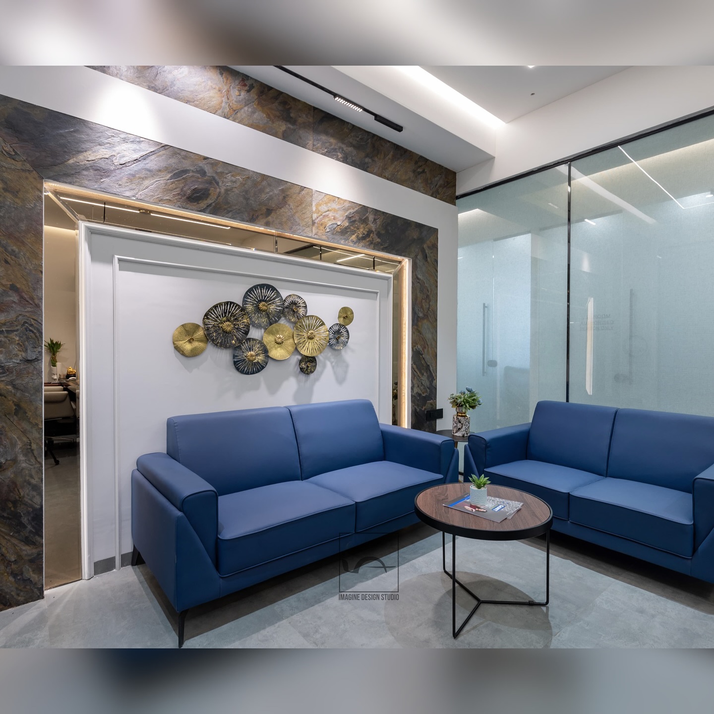 This corporate office designed for @ganitstarengineering located at Sinhasa, Indore is spread over an area of 4000 square.ft.
.
.
The interior of this office is designed with a careful composition of clean, straight lines and walls finished with a white-wash effect.
This combination creates a bright, open, and airy environment that encourages concentration and enhances productivity. The overall design embodies a modern, minimalist aesthetic, thoughtfully blending natural, rustic finishes with sleek glass accents.
The use of specific wall finishes such as stone cladding, exposed concrete finish and subtle paint finish, introduces a sense of warmth and texture, providing a striking contrast to the cooler, contemporary elements in the space.
.
.
.
This fusion of industrial functionality, modern design, and cultural storytelling creates a unique and inspiring workspace, reflecting both the company’s values and the spirit of innovation.
This thoughtfully crafted space not only embodies the company’s commitment to design and innovation but also serves as a testament to the power of creativity, functionality, and cultural connection in shaping a dynamic and productive
work environment.
.
.
Designed @imagine_design_studios @architect.ankitmittal @id.parakhgupta
.
.
Master cabins for @amitgoyal4367 @gunjeet17vinny @badjatyanimit
.
Captured by - @imagix_studi0
.
.
#interiordesign #indorearchitects #architecture #interiorstyling #interiordesigner #luxuryinteriors #corporatelife #corporatedesign #corporateoffice #corporateofficedesign #corporateofficeinteriors #corporateofficespace #officedesign #officeinteriors #officeinteriordesign #instadaily #trendingreels #explorepage✨