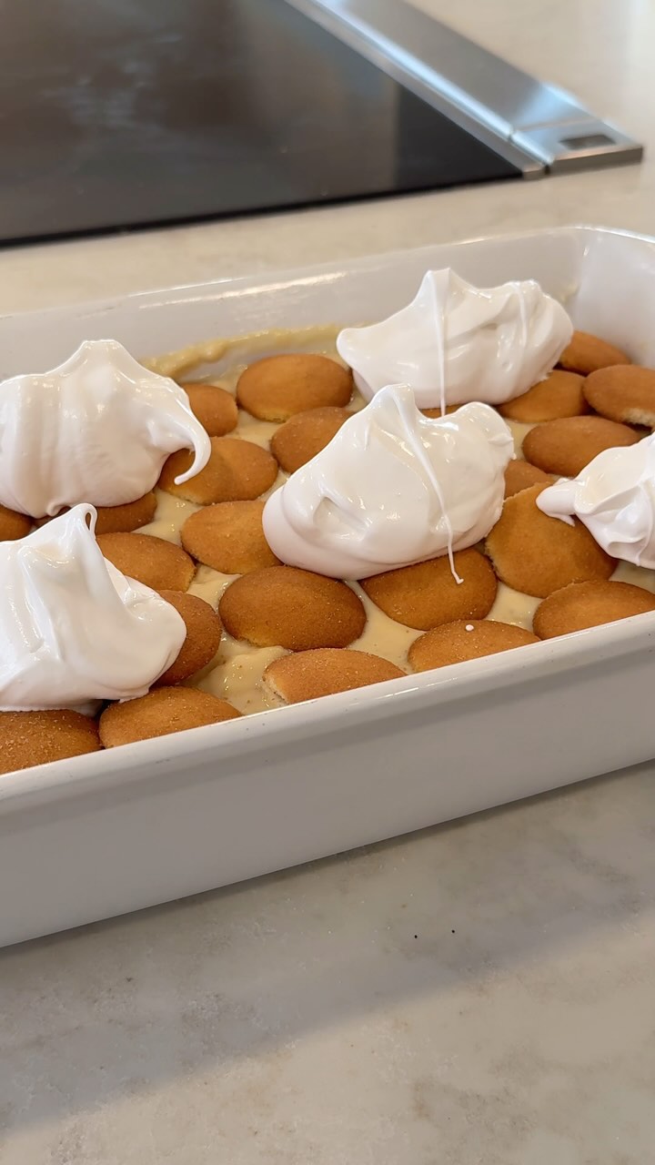 For my dad’s birthday, I made a family favorite: BANANA PUDDING, with perfect layers and homemade pudding.🍌 Warm banana pudding on a -1-degree evening was the perfect way to celebrate with love, laughter, and layers of creamy goodness!
Start with the vanilla pudding! 🍨 I know it’s tempting to buy pre-made pudding, but I REALLY recommend making it from scratch. It adds such a layer of love to this dish, and in my opinion, it makes it 100x better. 🤭
Pudding:
• 1/3 cup flour
• Dash of salt
• 2 1/2 cups milk
• One 14 oz can of sweetened condensed milk
• 2 egg yolks
• 2 teaspoons vanilla
First, add the flour and salt to a saucepan. Set it over medium heat and slowly whisk in the milk, sweetened condensed milk, and egg yolks (save the egg whites for later). Stir for about 8 minutes until thickened, then add the vanilla. Remove from heat and set aside.
Layers:
I used about 8 bananas and a whole box of Nilla Wafers.
Pro tip: I cut the bananas lengthwise to save time and space—trust me, setting down little banana coins gets boring fast! Here’s how to layer it: bananas, half of the pudding mixture, a layer of wafers, and repeat.
Meringue:
• 4 egg whites
• 2/3 cup sugar
For best results, use a chilled bowl! Beat the egg whites on high speed until frothy, then gradually add the sugar. Keep beating until the sugar dissolves and stiff peaks form. Spread the meringue over the pudding (I used half for piping on the sides, but you can use all of it on top). Bake at 325°F for 25 minutes, then let it cool for 30 minutes.
Enjoy with friends or family!#homemade #dessertlovers
#foodie #birthday #partyfood #hosting #bannapudding