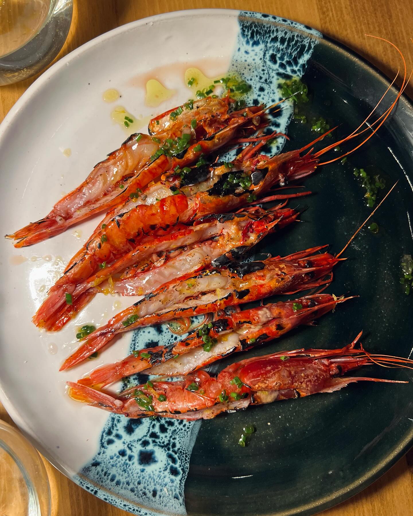 An Evening at The Seafood Market with Zafrana 2022
Our journey brought us to The Seafood Market in Gzira, a casual yet charming spot celebrated for its fresh, top-quality seafood. Its inviting atmosphere and creative dishes made it the perfect setting to pair with Zafrana 2022. We brought along two bottles of this exceptional wine, crafted entirely in stainless steel to preserve the purity of Malta’s terroir. With crisp acidity, citrus notes, and a distinct saline minerality, Zafrana 2022 elevated every course of this Mediterranean feast.
We started with mussels and Pink Tarbouriech oysters, their briny freshness beautifully complemented by the wine’s bright citrus undertones. Local mackerel with citrus labneh and anchovies ‘angelachue’ followed, with the wine’s acidity cutting through the richness, creating balance.
The standout dishes included local Rossi prawns and seared scallops with oyster mushrooms. Zafrana 2022’s refreshing profile and medium body enhanced the natural sweetness of the seafood, while its layered complexity added depth.
For mains, monkfish tail wrapped in nori with tiradito sauce, baby calamari with sauce verte, and grilled octopus on hummus took center stage. The wine’s saline minerality and vibrant character paired seamlessly, highlighting the delicate flavors of these dishes. We ended with bouillabaisse fish stew, its hearty flavors balanced by the wine’s refreshing finish.
The Seafood Market’s dedication to fresh seafood and thoughtful preparation perfectly matched Zafrana 2022’s vibrant character, making this a memorable chapter in our Wine & Dine Journey.
#MarkusDivinus #Zafrana2022 #TheSeafoodMarket #WineAndDineJourney