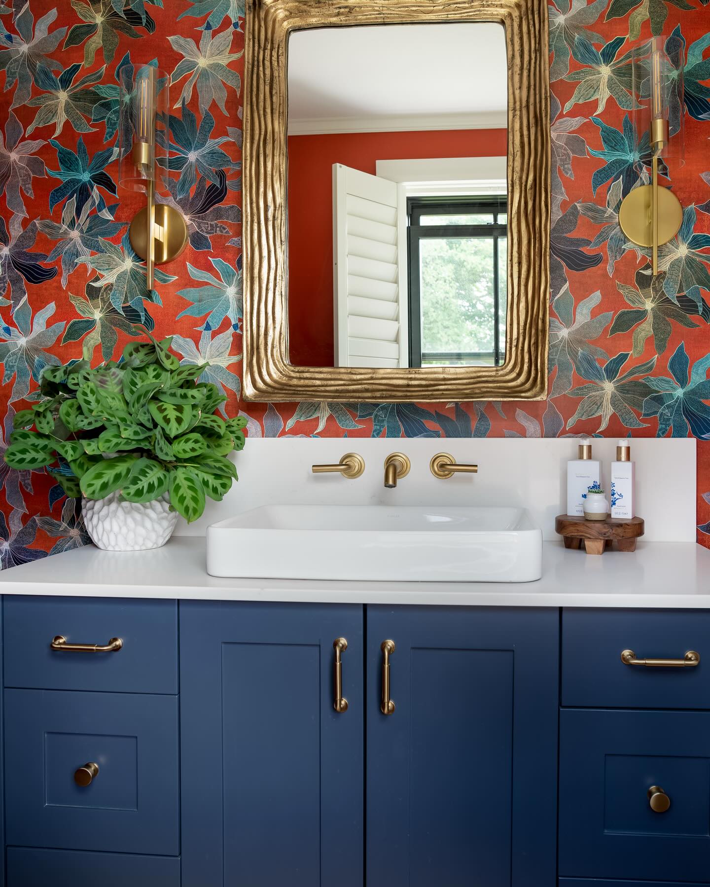 This powder room started with a love story—I fell head over heels for this bold botanical wallpaper and built the entire design around it. The deep navy vanity was the perfect complement, adding a grounded contrast to the vibrant pattern. To add even more history and character, the wood floor was salvaged from the original 1652 home, bringing a touch of the past into this bold, modern space. 🌿✨
Builder @jsv.llc
Photographer @jessicadelaneyphotography
#PowderRoomGoals #WallpaperLove #BoldInteriors #CustomDesign #InteriorInspo #LuxuryDesign #StatementWallpaper #historiccharm