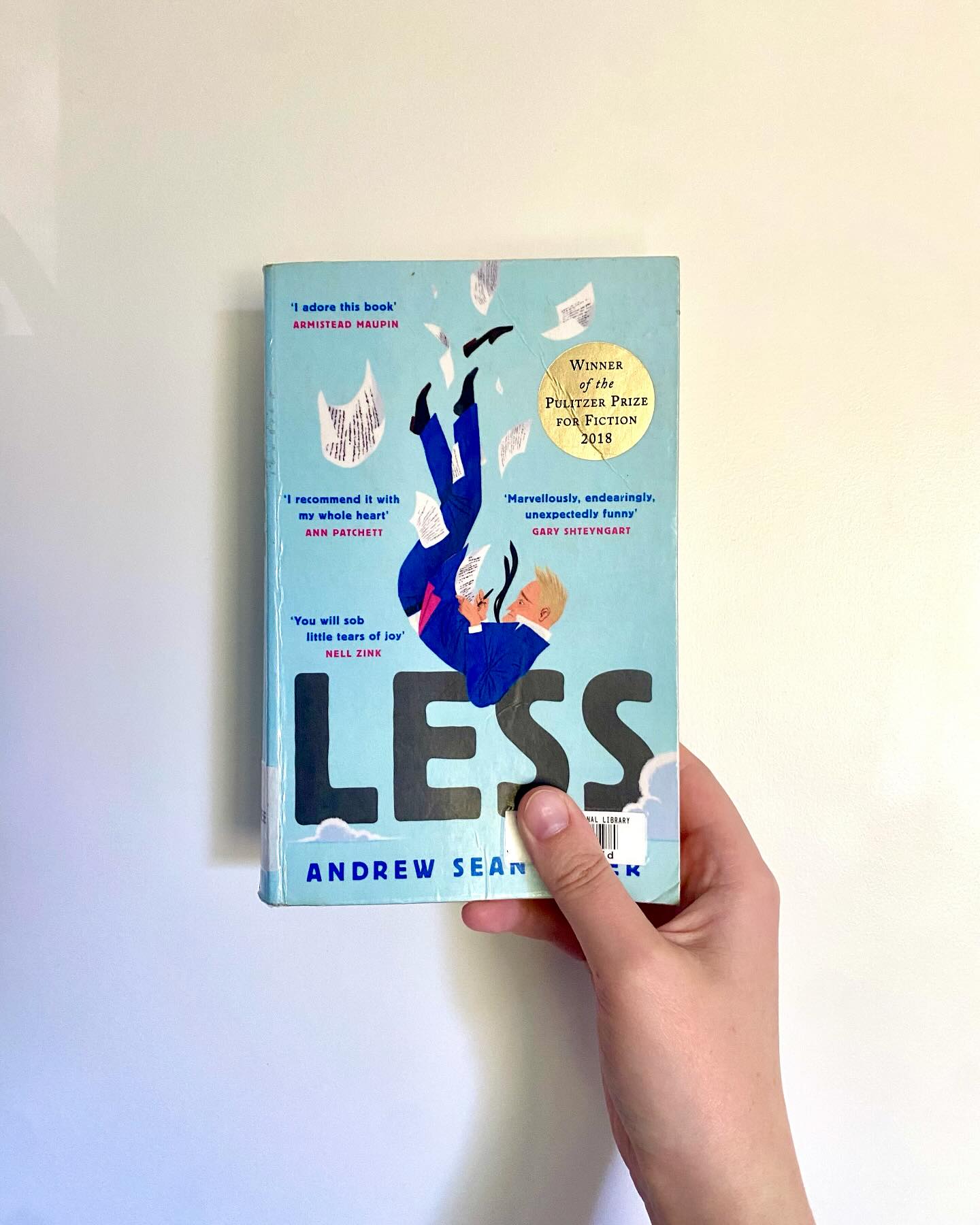 âLessâ, Andrew Sean Greer
Who says you canât run away from your problems?
Arthur Less is a failed novelist about to turn fifty when he receives an invitation to his ex-boyfriendâs wedding. He canât say yes â it would be too awkward; he canât say no â it would look like defeat. So, he begins to accept the invitations on his desk to half-baked literary events around the world. Anything to take him away from his exâs wedding.
ID: a pale hand holding up the book âLessâ against a white wall.