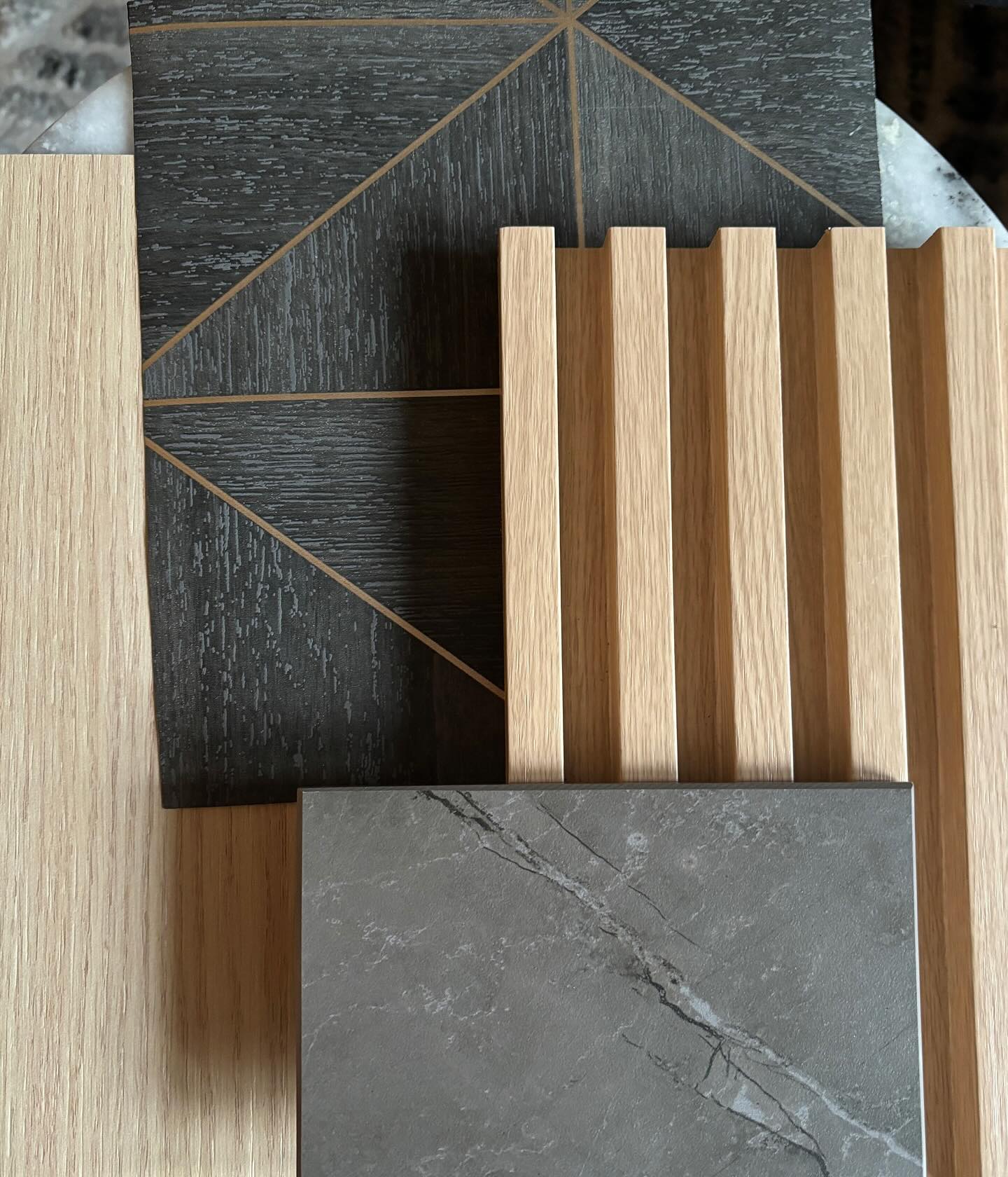 Powder Bath Warm Modern: oak cabinetry, Dekton floating vanity, tambour wall cladding and wood look wallpaper set the stage for a modern yet warm architectural vibe. #customhomeonteriordesign #monicamachadesign#warmmodern #cosentinousa #boiseinteriordesigner