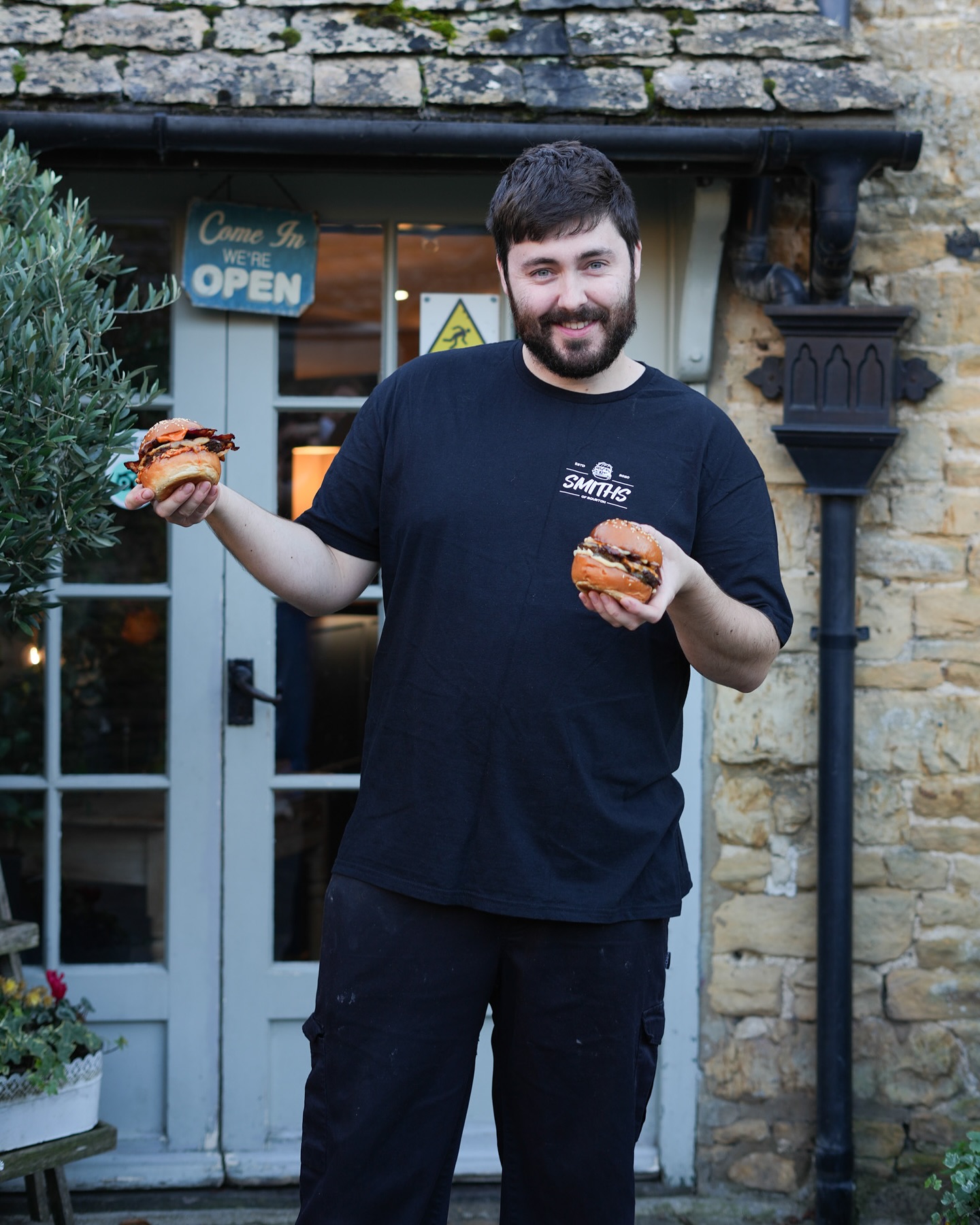 Meet Theo– Co-Owner of Smiths Restaurant
With experience in top kitchens like The Grove at Watford and The Mash Inn at Radnage, Theo has brought his passion for quality food to Smiths. Since 2020, he and his brother Sebastian have put their own hallmark on the burgers they serve today.
In Theo’s words: “Initially, Smiths had a concept of serving hearty Italian dishes, such as homemade lasagnes. It started to take off. However, for us, something didn’t feel right. After a few weeks of serving takeaway Italian food over lockdown, we decided to use lockdown to our advantage and try out something different.
So we started flipping burgers! And we’ve not looked back since!”