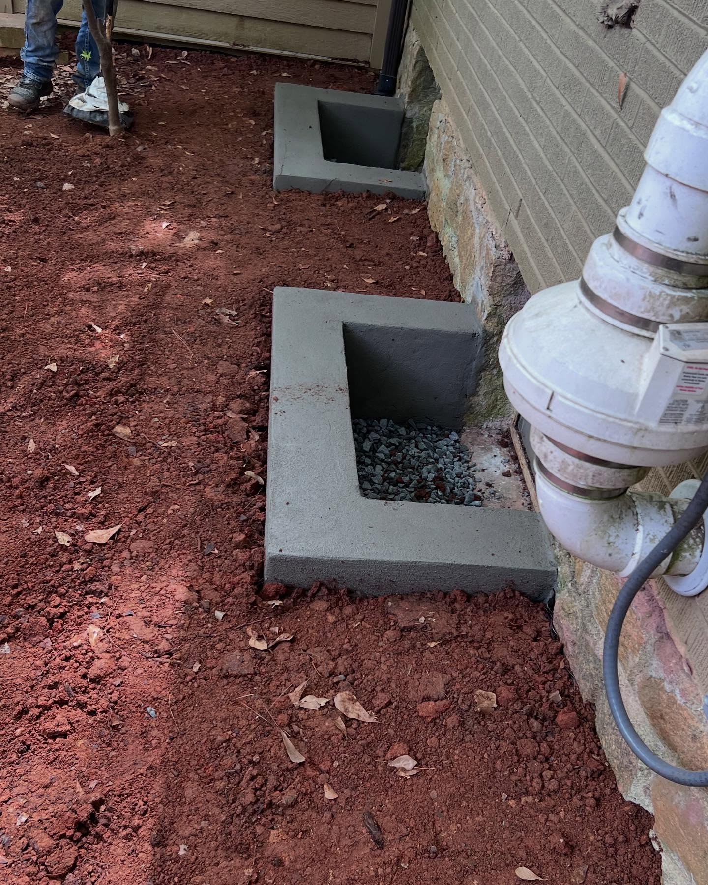 Window well project we just finished up with! This customer had some old aluminum window wells here that we replaced with CMU block. Prior to installing the window wells, we installed a French drain system and buried the downspouts. Once the window wells were installed, we utilized the left over soil to get a positive gradient away from the foundation. @atldrainpros
#drainagecompany #drainagecompaniesnearme