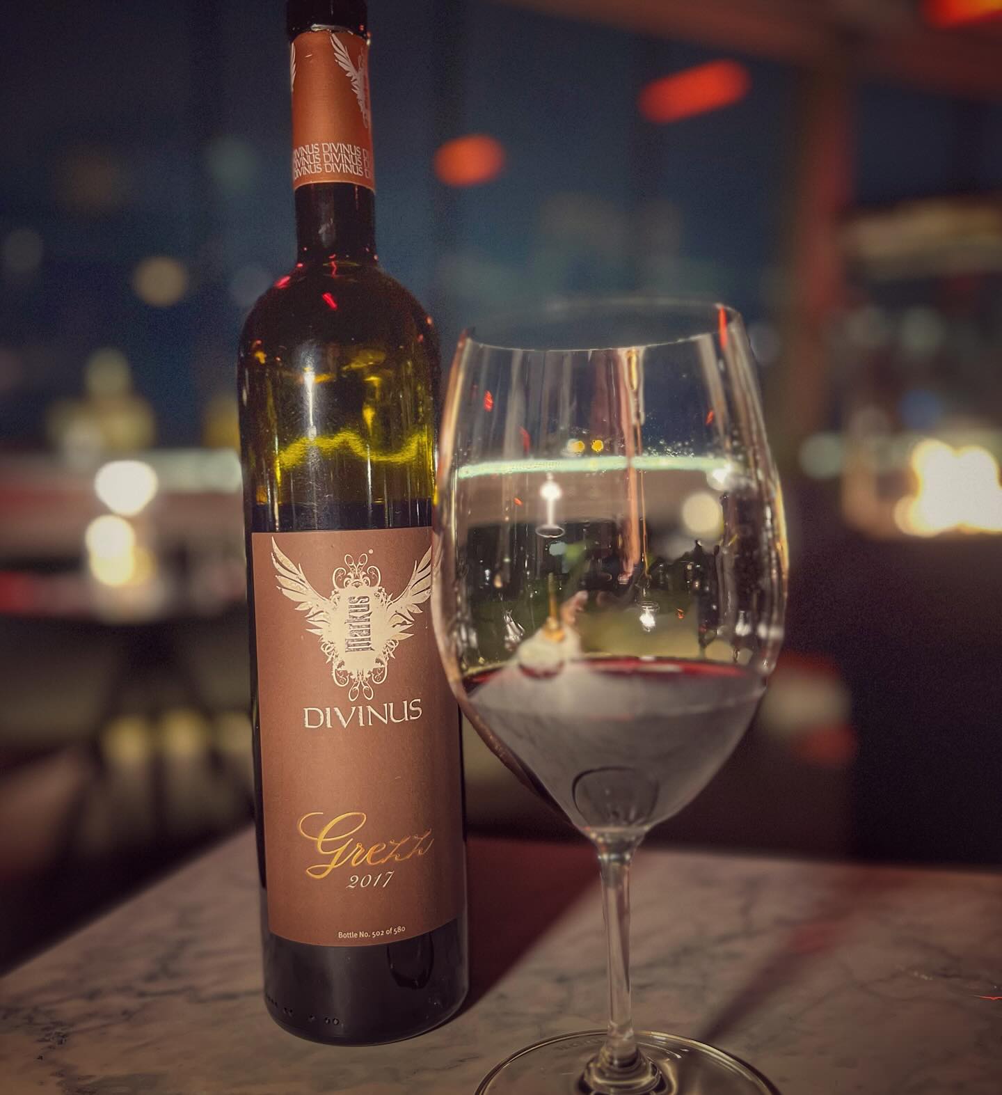 An Evening at Chophouse with Grezz 2017
Chophouse was one of the first restaurants to feature Markus Divinus wines, making it the perfect place to celebrate this collaboration. With breathtaking views of Valletta, impeccable service, and a vast selection of Markus Divinus wines—including a few off the list if you ask—it was a night to remember.
For the occasion, we opened Grezz 2017, a blend led by Merlot, with Cabernet Sauvignon and Syrah (Solum) adding structure and spice. This unique vintage showed remarkable depth, balancing dark fruit, peppery notes, and smooth tannins with freshness and aging potential.
We started with a ricotta and lemon cream amuse-bouche, followed by the grilled rack of lamb with pumpkin seed and herb purée and the Uruguayan prime beef fillet with black garlic purée and red wine jus. The balance of flavors was spot on, and Grezz 2017 held its own beautifully, enhancing every bite.
To finish, we indulged in a dark chocolate fondant, a rich and decadent dessert that paired beautifully with the wine’s velvety texture and lingering fruit notes.
Chophouse’s dedication to quality, both in food and wine, made this a truly special evening. Whether choosing from their curated list or exploring something off-menu, this is a place where great wine and food come together perfectly.
#MarkusDivinus #Grezz2017 #ChophouseMalta #WineAndDineJourney