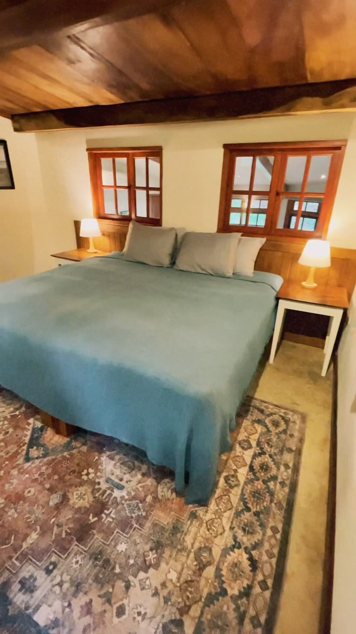 New rental at La Finca! Nestled in lush tropical gardens just steps from Cambutal’s black sand beach, this one-bedroom rental blends rustic charm with modern comfort. A unique, thoughtfully designed space, it’s been built piece by piece, resulting in an original yet stylish retreat with all the amenities you need.
Inside, the bedroom offers flexibility with a king bed that can be converted into two twin beds, plus a dedicated workstation for remote work. The bathroom features terracotta tiles, a stone-floor shower and a hand-painted sink from Mexico.
The living area boasts a cozy full-size sofa and large windows that frame ocean views, while the fully stocked kitchen includes a stove, oven, and stainless steel cookware—perfect for cooking fresh local ingredients.
Step outside onto your private patio, where you can sip your morning coffee while gazing at the Pacific. A private path leads directly down to the main street, putting the beach just across the road.
For added convenience, the rental includes air conditioning, hot water, high-speed WiFi, and a full backup generator to ensure uninterrupted comfort. Whether you’re here to surf, relax, or explore Cambutal’s natural beauty, this one-of-a-kind retreat offers the perfect blend of privacy, style, and adventure.