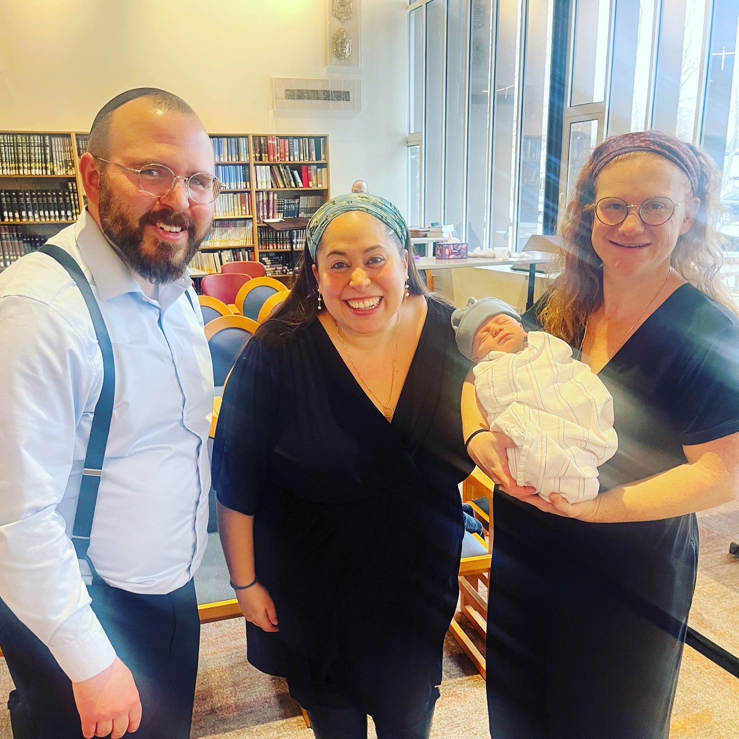 ✨ Seffi’s Bris – A Celebration of Love, Legacy, and Community✨
At Hebrew College, in a room filled with warmth and joy, we gathered to welcome Aviv Yosef (Seffi) into the covenant of the Jewish people. His parents, Elana & Sarah Pollack, crafted a ceremony that was deeply personal yet profoundly communal, weaving their own family traditions into the rich fabric of Jewish continuity.
A particularly moving moment came at the conclusion of the bris, when Elana and Sarah offered a special rendition and melody of Birkat Habanim to their sons, Seffi and Avri. Their voices carried not only blessing but a powerful affirmation—of love, of commitment, and of their dedication to flourishing of our people.
This bris was also a reunion, a testament to the way Jewish life connects us across time and place. I first met Sarah when she was working with Encounter Programs, in which I participated multiple programs, and it was through Encounter that I also met Rabbi Shani Rosenbaum, who was working alongside her. To now stand together, years later, in a moment of joy and new beginnings was profoundly meaningful.
Beyond those connections, this gathering brought together people from so many different corners of my own life—friends (shout out to Anna Wolfe!), colleagues, and familiar faces from unexpected places—all drawn together by the power of simcha and the transcendence of our Mesorah, tradition. Moments like this are a reminder that even in times as difficult as these, the Jewish people continue to love, to embrace and to build.
Under Rabbi Shani’s thoughtful leadership, the ceremony embodied everything a bris should be: a joyous welcome, a recognition of history, and a promise for the future.
Seffi, may your life be filled with light, meaning, and endless love.