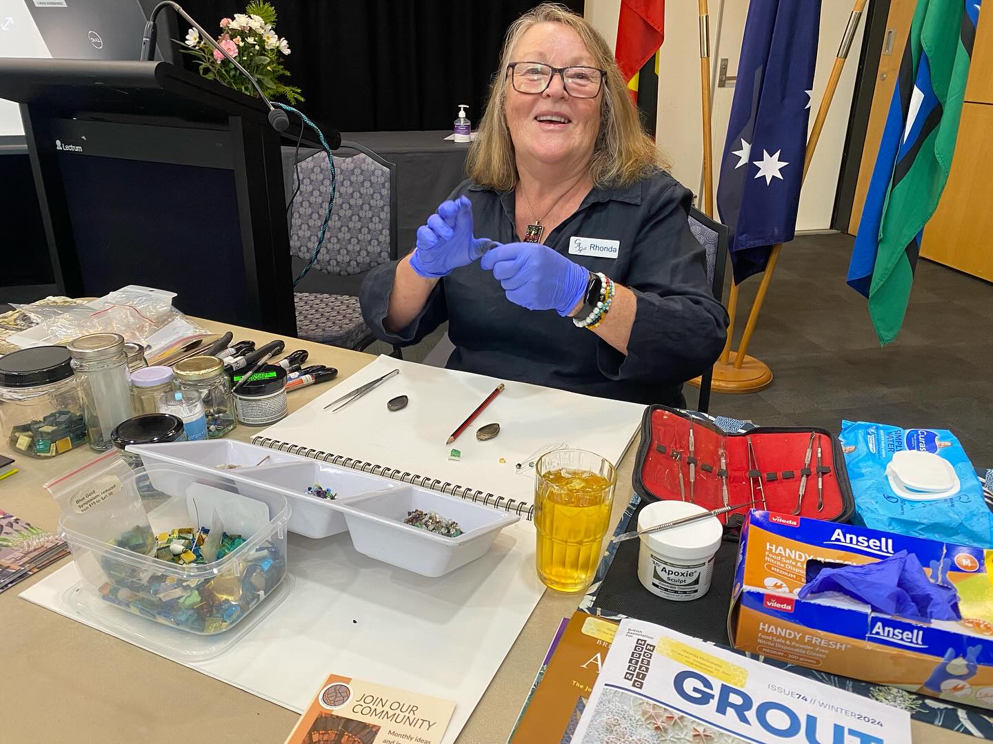 Rhonda doing a Mosaic Jewellery demonstration. Using Apoxie Sculpt, cut up tiles, glass & precious stones.