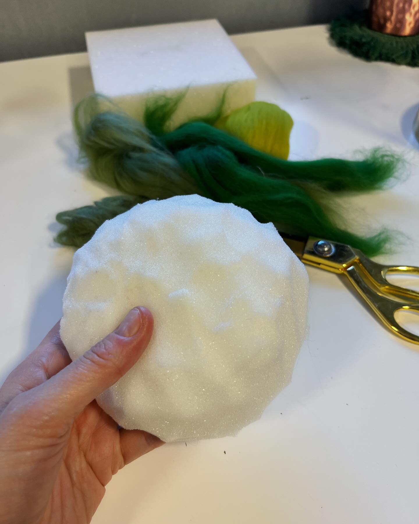 So this is what I’m up to today! I thought I’d share this little process of taking a felted model and creating a mini scene to bring him to life.
Firstly, I measured the base of a large glass cloche onto one of our old felting mats and used a big pair of scissors to cut the foam into a rough mound shape.
Then, I took some forest green merino wool fibre and tore it up, rubbed it in my palms to make a pad and then felted this over the mat.
By adding lots of patches, I covered the base to make a grassy little hump.
Using wisps of wool in grey, brown, eggshell cream and olive green, I made a series of little balls, which I’ve felted onto the mound to make a sweet little path.
I used the flowers that come in the kit to decorate the scene and filled his sack with mini felted eggs.
Ta-da! He’s ready to deliver his gifts to all the good little boys and girls :)
We get asked all the time about what to do with finished models and so this should make a nice little prop for the two big craft shows we have coming up.
What are you up to today?
#needlefelttutorial #feltbunny #eastercraft #needlefelting #easterbunny #berginandbath #fyp #felting #needlefelting