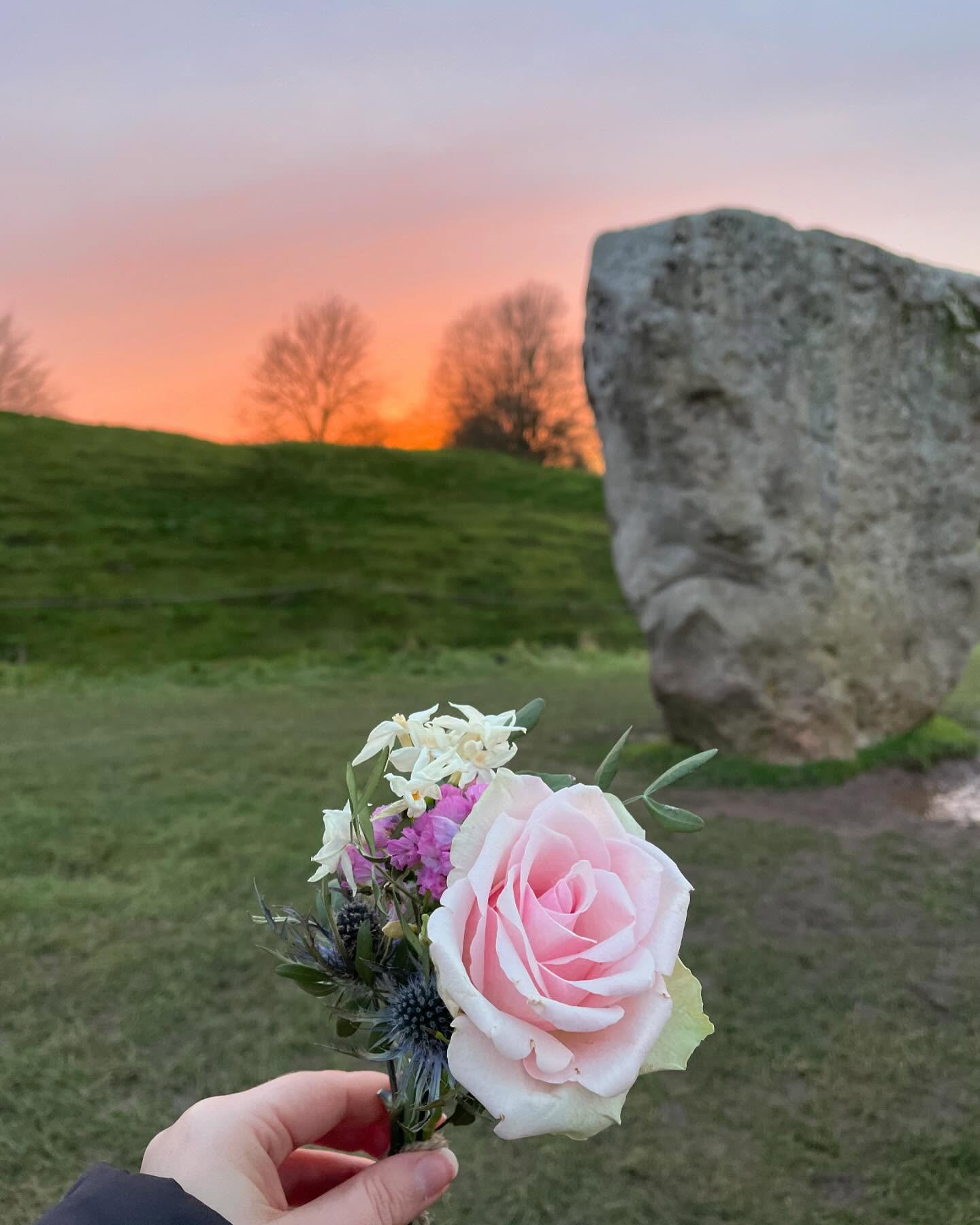 Sharing a moment of awe and beauty from a recent trip to Avebury ✨
Avebury is a special place for me and has held space for my own grief tending rituals over the years. Especially since my dad passed away as it was a special place for him too. We visited together once and I feel a comfort in this place as I feel it holds his energy.
I made this flower posie from a mix of flowers I had gifted myself at home and that were gifted to me from a beautiful sisterhood circle I attended. I like to offer them back to the land as part of my ritual in honouring loved ones I have lost. 💐
I am living away from my home town where both of my parents are buried. So trips to the cemetery to take flowers isn’t always possible. Creating my own rituals to honour my loved ones has become a big part of my own grief tending journey and it helps me to feel more connected with them in doing this.
I offered the flowers to the stones. Remembering and honouring all those that have walked this path before me and the many more that will follow too. I hoped that in others seeing them left there, they would also be a reminder of the beauty this life holds too 💖
P.s. how magical are those skies?! 😍
#avebury #aveburystones #aveburystonecircle #ritual #ritualmagic #griefritual #sacredsites #pinkskies #pastelsky #natureritual #grieftending #grieftendingritual #griefjourney