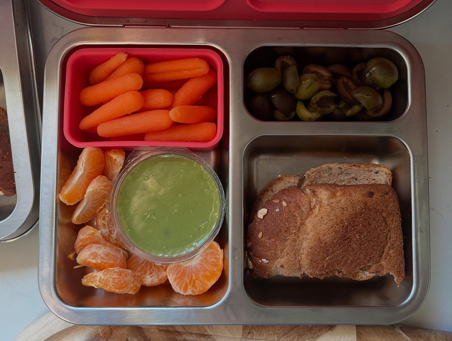 #vegan #lunchboxforkids! Our whole family went plant-based in 2024, and our preschool and elementary-aged kids have adapted so well. This picture is a fairly typical plant-based lunch box for them. We try to incorporate fruits and veggies as well as nuts, but we also do some prepackaged foods. What is most important for us is that our kids are eating plants and less-processed foods, but that doesn’t mean we avoid all pre-made foods in the store.
Pictured above: halved pre-pitted olives, carrots and guac, mandarin orange, and pb&j on whole wheat bread.
#wfpb #plantbasedonabudget #plantbasedfamily #whatsforlunch