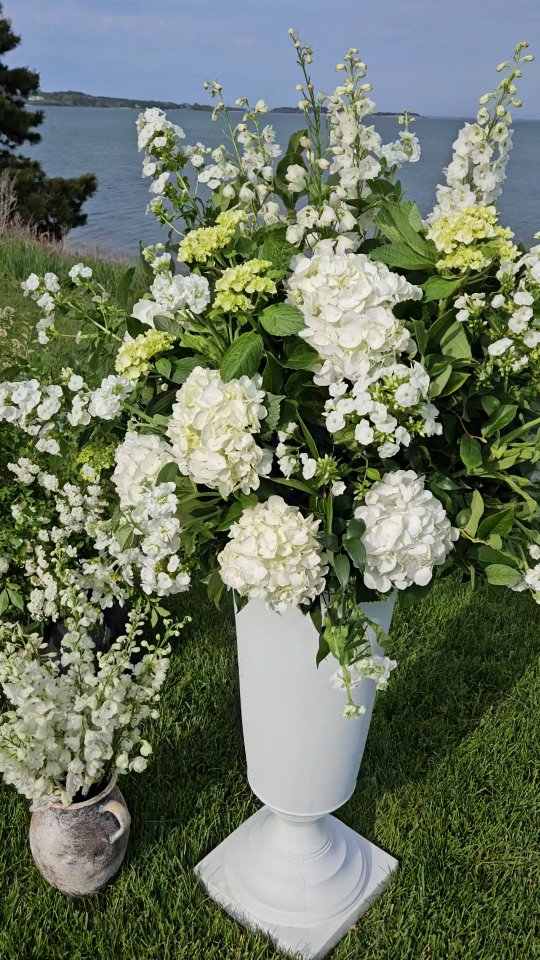 It seems like there has been a focus on arbors as ceremony decor over the past few seasons, and while we love them, revisiting this design has us thinking about all the benefits to big ceremony arrangements:
✨️ Maximum repurposing opportunities - these are relatively quick and easy to move to the reception for the Head Table/Sweetheart Table, console tables, the bar, etc...
✨️ Budget friendly - these use considerably less materials than floral pillars or a fully covered arch, so if you are in the 6-10K investment range these will help you stay on target
✨️ Classic style - this look doesn't feel like a trend, it is timeless with tons of ways to play around with the shape of the arrangements
✨️ Keep the focus on you without disrupting the view - most of the time we have a breathtaking backdrop and these are such a nice way to compliment the scenery while allowing you to shine
.
Looking for a florist for your 2026 Cape Cod wedding? We would love to hear all about your vision for the day and dream up some beautiful designs to celebrate your love! Contact us through the link in our bio!
.
Planner: @jyldeering
Venue: @wequasset