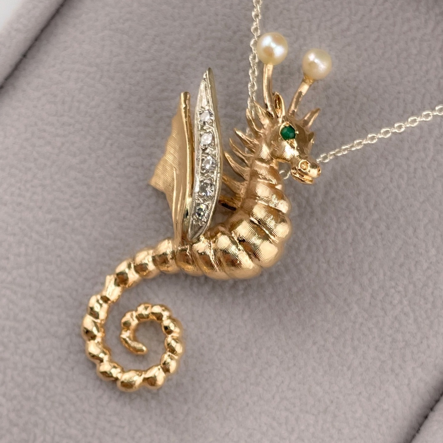 This gold seahorse dragon pendant with emerald, diamond, and pearl accents just might be the sweetest, most whimsical piece of vintage jewelry to come through HJ yet…And the PERFECT anniversary present to celebrate a life sharing a love for the Florida Keys, the arts, one-of-a-kind fine jewelry, and each other!
.
#voilà, #gold, #customjewelry, #vintagejewelry, #custom, #vintage, #benchjeweler, #whimsical, #emeraldeyes, #whimsy, #floridakeys, #theartisthouse, #seahorse, #loveletters, #happyannivesary #nh, #newhampshire, #nhjewelers, #livefreeandshine, #thepeoplesjeweler, #hampsteadnh, #atkinsonnh, #salemnh, #plaistownnh, #eppingnh, #exeternh, #hamptonnh, #kingstonnh