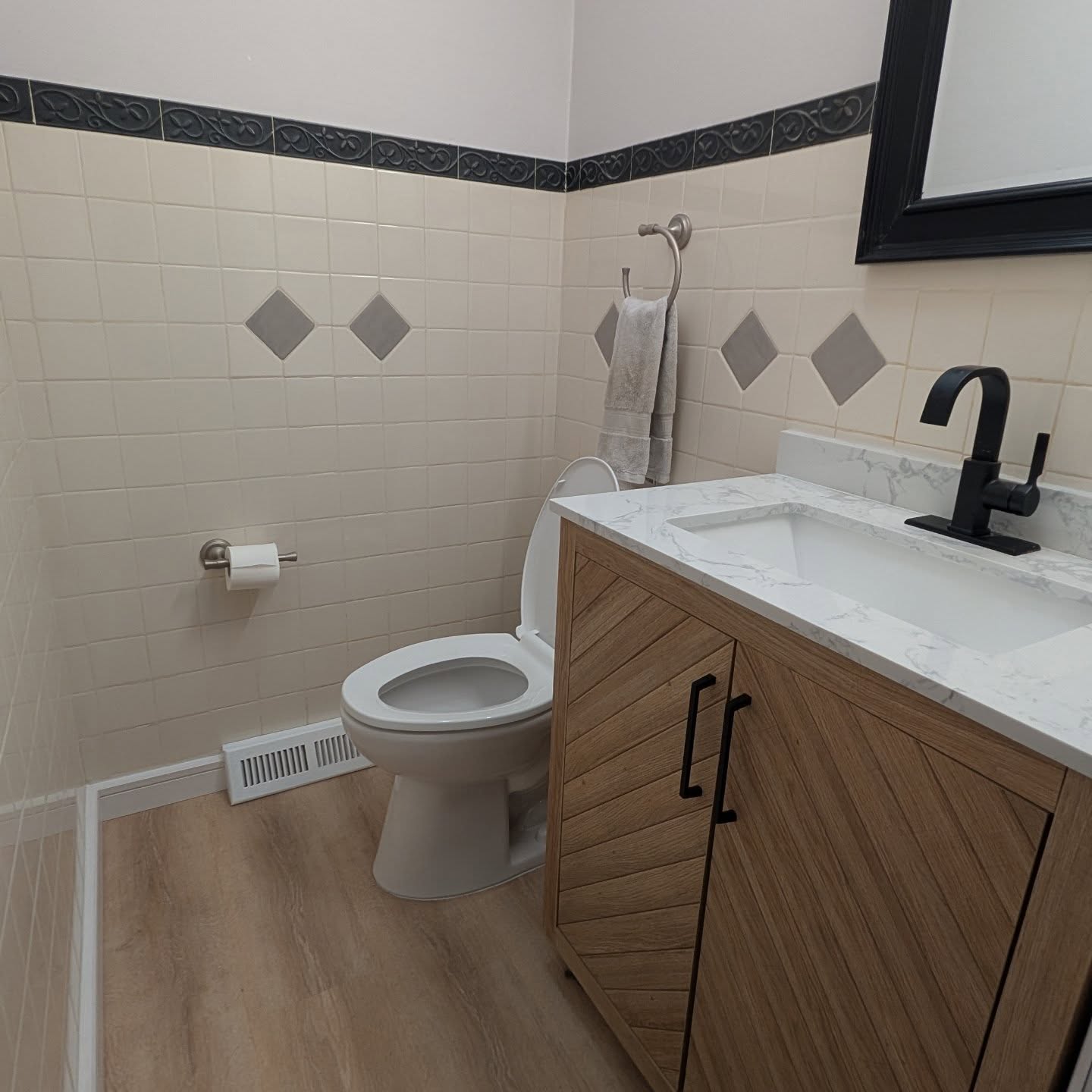 We updated the bathroom, new wide plank luxury vinyl floor in the living room and new window casing to give the house a final update to the first floor living spaces.