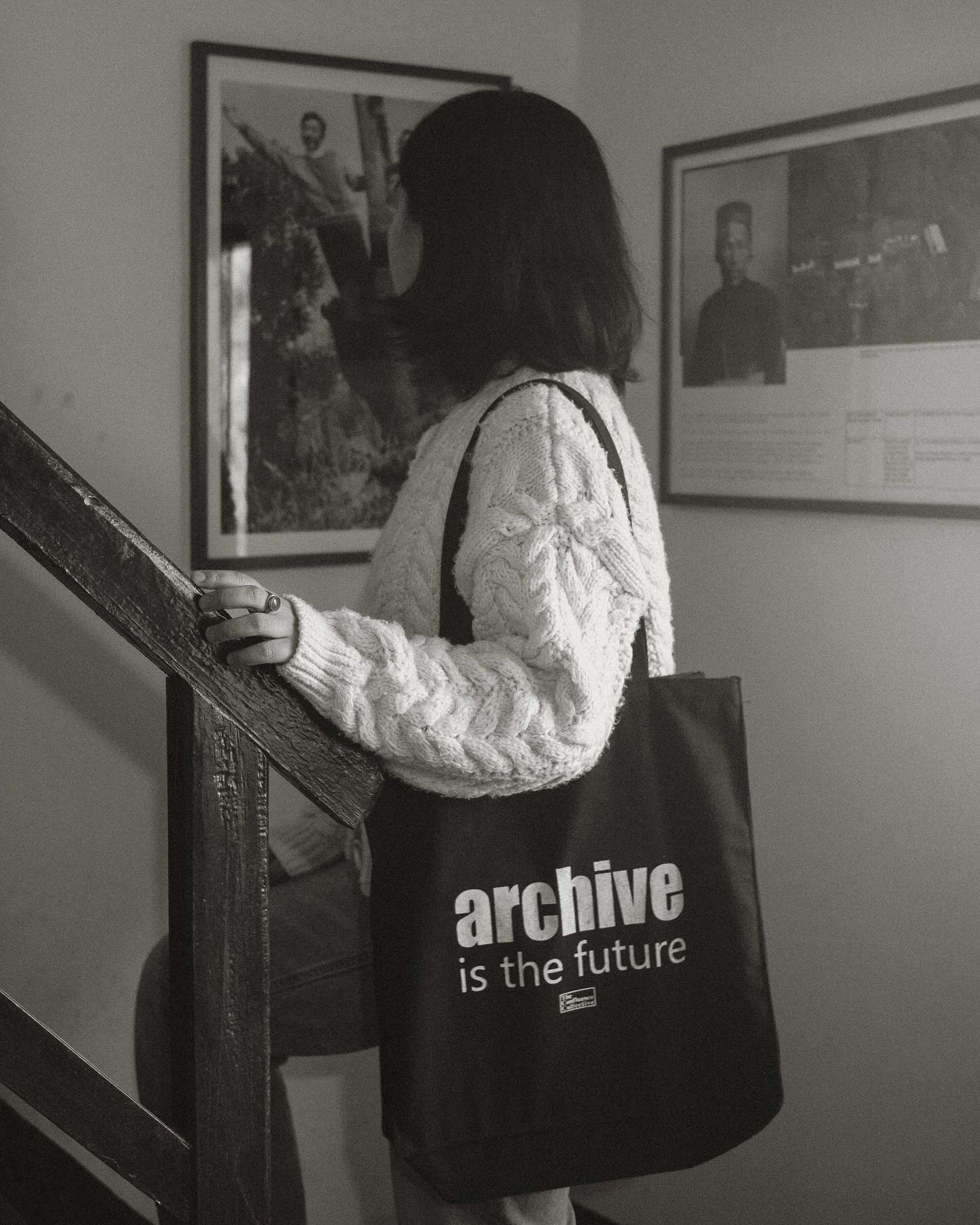 Get your TCC tote bag
Link in bio
“ARCHIVE IS THE FUTURE” reflects the idea that preserving our collective history, experiences, and knowledge today is key to understanding and building the future. At The Confluence Collective, we believe that archiving whether it’s through art, stories, or community initiatives helps to safeguard important narratives that can inspire, inform, and guide future generations.
In a world that is constantly changing, archives act as a bridge between past experiences and future possibilities. By maintaining and sharing these records, we ensure that the richness of our shared history continues to influence, uplift, and inform the ongoing journey of growth and progress.
Every purchase directly contributes to:
* Documenting and preserving local histories and cultural narratives
* Supporting community-based programs in the Darjeeling-Sikkim region
* Empowering future generations through education and cultural preservation
Join us in our journey to create a more informed, inclusive, and sustainable future. Carry your beliefs and support our cause with pride, knowing that every purchased makes a difference.
Photo @brihatrai