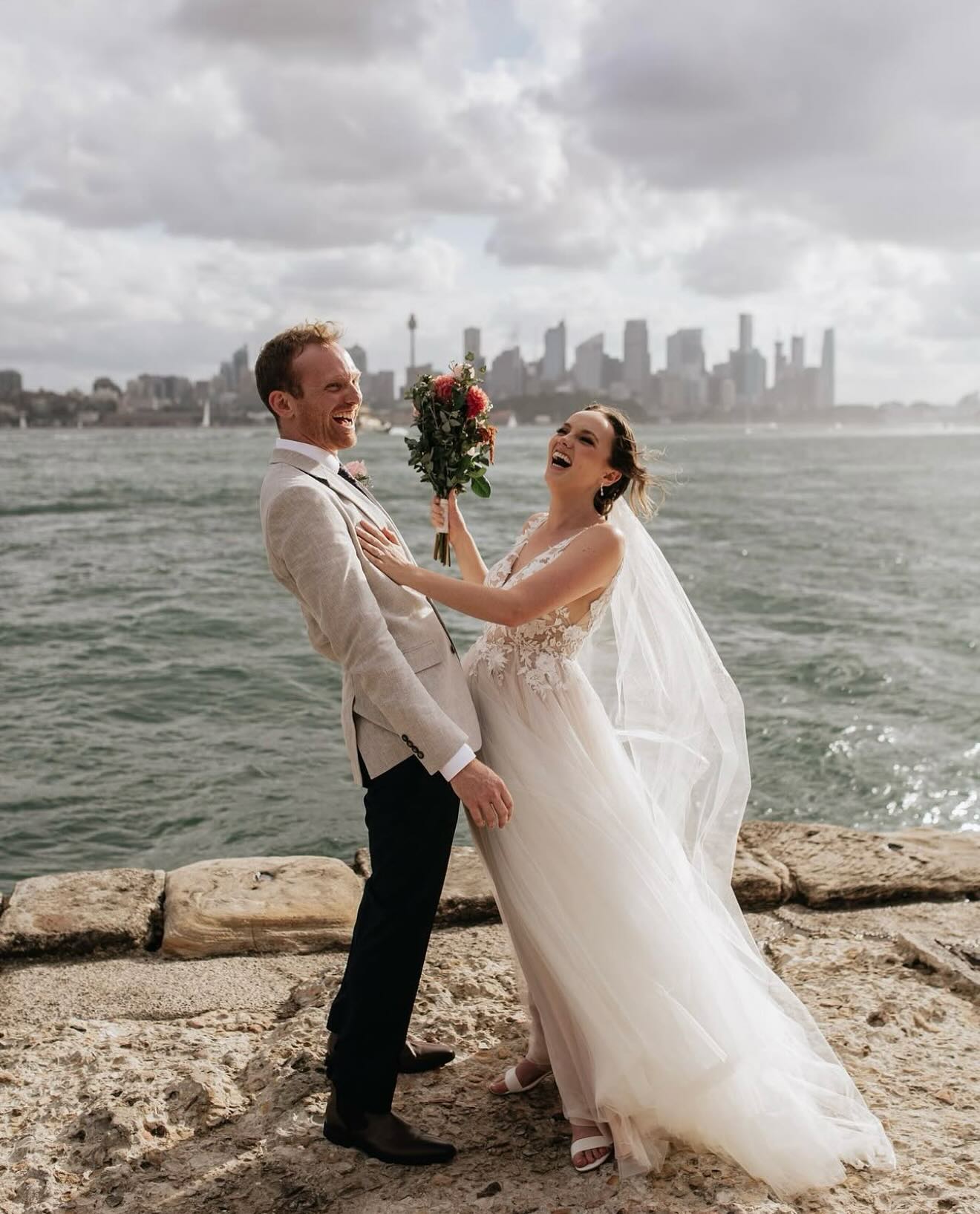 Almost 2 years ago, I had the most amazing time marrying these two legends, Alex and Nic. Now, this weekend, I get the honour of marrying their best mates, Bri and James! I love getting to see couples I’ve married before at their loved ones’ ceremonies. 🥰
Truthfully, Alex wasn’t super excited about the ceremony part of the day (we listen and we don’t judge 😂), but I was beyond thrilled when I got an email from her after the big day saying it was perfect and way more fun than she expected (among other lovely things)! 🙌🏼
Ceremonies are such an important part of the day, and they don’t have to be something to dread. 😅 In fact, they can be the highlight! After all, how could a ceremony all about you two be boring?! Alex and Nic are self-proclaimed as the funniest people they know (and I’ll totally back them on that one, they are hilarious)! It was such a fun day with a perfect couple. 💕
Here is what Alex and Nic had to say about my services:
“We cannot fault our experience with Beck at all! We searched the internet far and wide for a celebrant that would match our vibe, and when we came across Beck, it was a super easy choice. We were after a fun and relaxed ceremony full of laughs and heart, and Beck nailed it! Our ceremony was legitimately perfect. We wouldn’t have changed a single thing. It was so personalised and so ‘us.’ She helped the day run seamlessly, and our guests haven’t stopped telling us how great she made the day. Our guests all gave us glowing reviews of Beck, so it wasn’t just us that was having a great time! Everyone loved it. On top of being awesome at her job, she’s just a super awesome person too. She’s so down to earth, easy to deal with, super responsive, and there to ease any nerves ahead of the day. I was so nervous for the ceremony, and I didn’t expect it to be that fun! Our photographer sent us a sneak peek of some pics, and your ability to seamlessly step out of the way of photos is truly amazing. I didn’t even notice you walking around! So impressive. Honestly, thank you so, so, so much; you were the best. 11/10 would recommend!!”
Photography: @jamesthomsonphotography