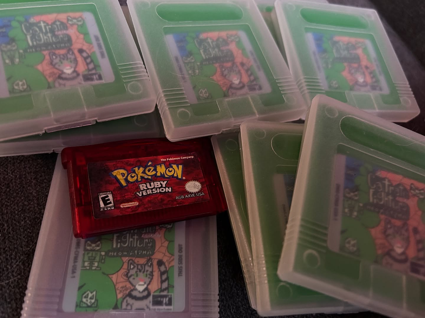 Testing out a new batch of green and gray Catraté Fighters: Meow Alpha Gameboy cartridges! I had to blow into a couple to get them working!