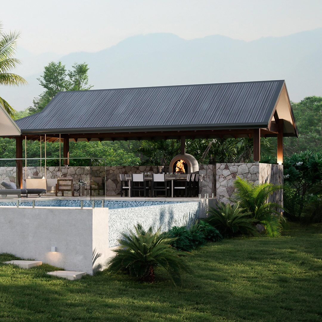 Our completed Facade Design for our Whitsundays Pavilion House, 10 minutes inland of Airlie Beach
The clients opted for the ‘Light’ colour scheme which we then brought to life with lighting and accessories and the pizza oven!
We worked closely with our energy efficiency consultant to get around the new NCC 2022’s limitations on dark roofs!
Colorbond’s Woodland Grey looks great in a natural setting and our 900mm wide eaves and corefilled blockwork walls help the thermal performance of the building in hot weather to offset the roof’s dark colour.
With our working drawings completed, we can’t wait to see how the construction goes.