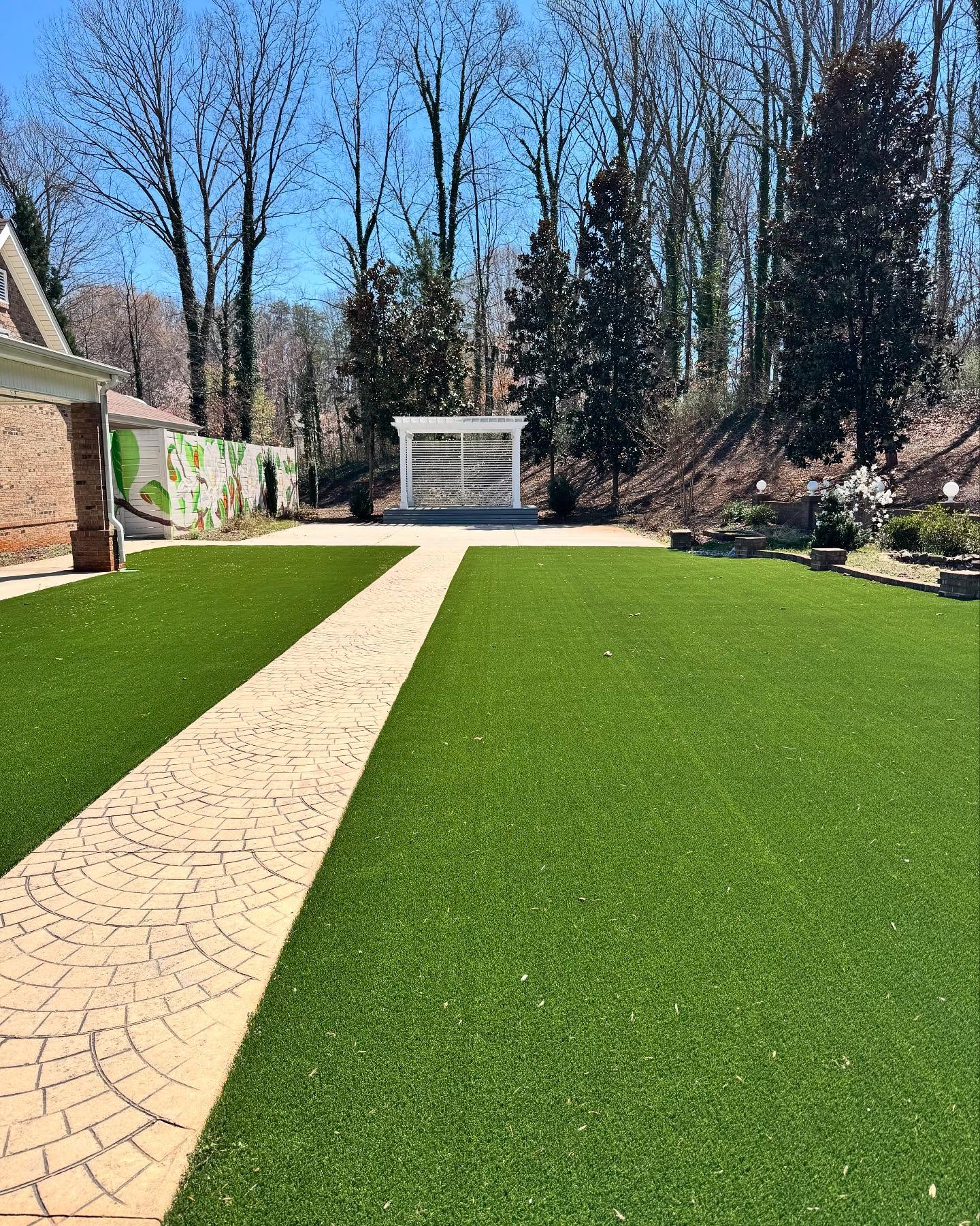 Say “I do” in the beautifully manicured outdoor ceremony space at Villa Magnolias Event Center, where a paved aisle leads to a charming white pergola nestled among towering trees. The serene surroundings and modern landscaping create an elegant backdrop for an unforgettable wedding day.
#greensboronc #greensborowedding #greensborovenue #ncweddings #ncweddingvenue #ncwedding