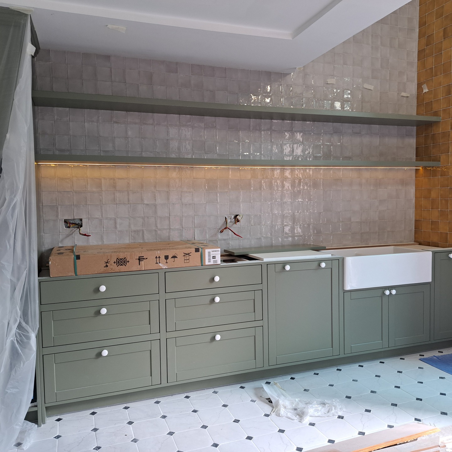 A work-in-progress in Business Bay. A fully bespoke in-frame Shaker kitchen painted in a beautiful green, with grey and yellow wall tiles 💛 Loving the large Butler's sink - a fireclay sink produced in Fujairah. Always supporting local businesses whenever possible 👏
.
.
.
#shakerkitchen #shakerkitchens #inframekitchen #bespokekitchens #bespokekitchensdubai #dubairenovations #dubairenovation #businessbay #dubaiinteriors