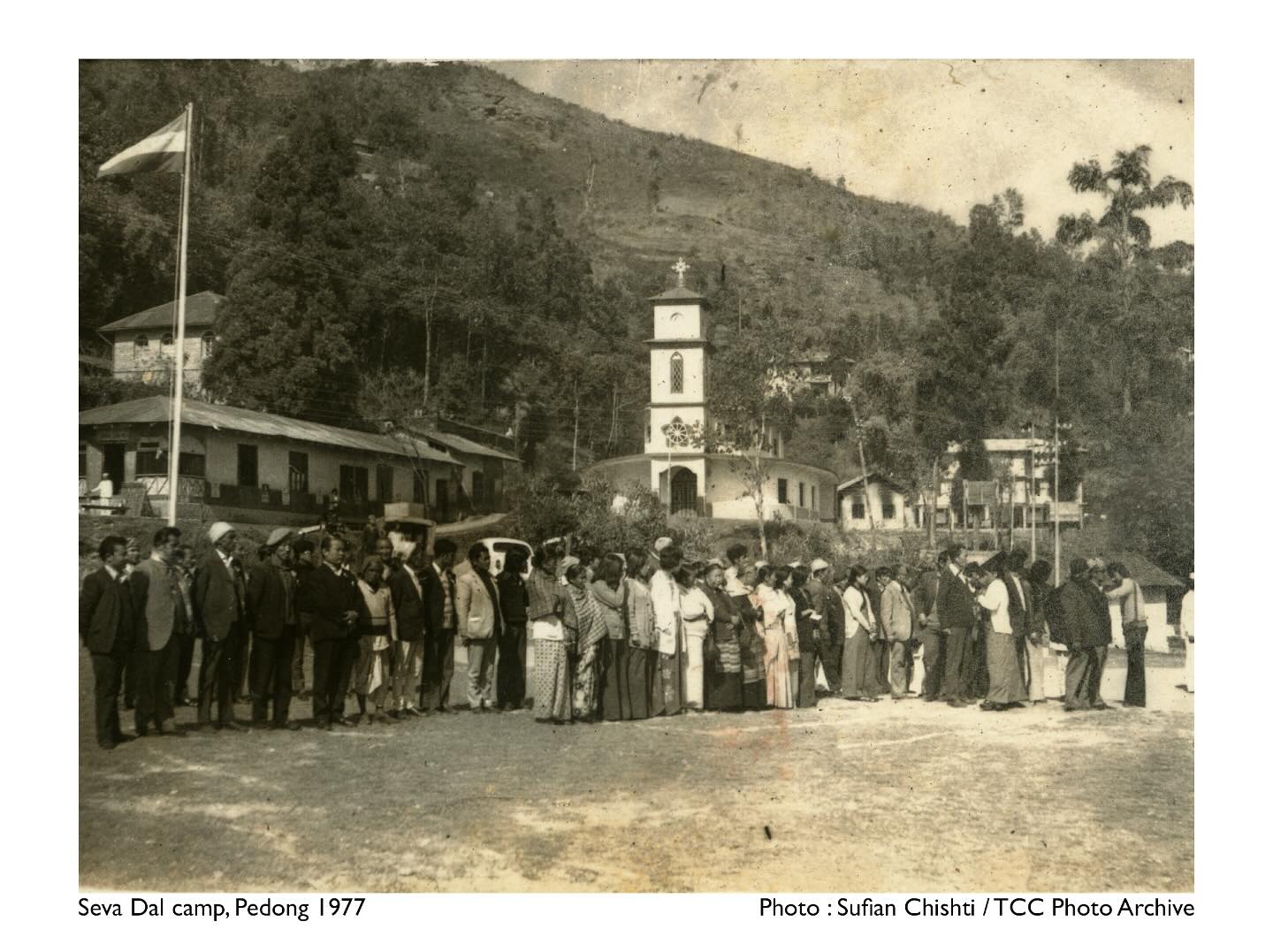 Seva Dal camp
Pedong, Kalimpong - 1977
Photo : Sufian Chishti / TCC Photo Archive
In 1977, the Seva Dal was significantly involved in social and political movements, continuing its legacy of volunteerism and service that began during India’s struggle for independence. While the Seva Dal initially had strong ties to the Indian National Congress (INC) during the freedom movement, in 1977, it found itself in a changing political landscape. This year marked a significant shift in India’s politics with the rise of the Janata Party, which came to power after the Emergency (1975-77) imposed by then-Prime Minister Indira Gandhi. The emergency period and the subsequent elections of 1977 led to the formation of the first non-Congress government in India.
The Confluence Collective has digital archive preserves over 10,000 photographs from the Darjeeling Hills and Sikkim, offering a window into the rich history and culture of these regions. The collection, made up of personal, institutional, and private stories, delves into themes of belonging and identity key to understanding the socio-cultural and political fabric of Hill society. By localizing knowledge production, TCC is helping decolonize narratives and amplify local voices.