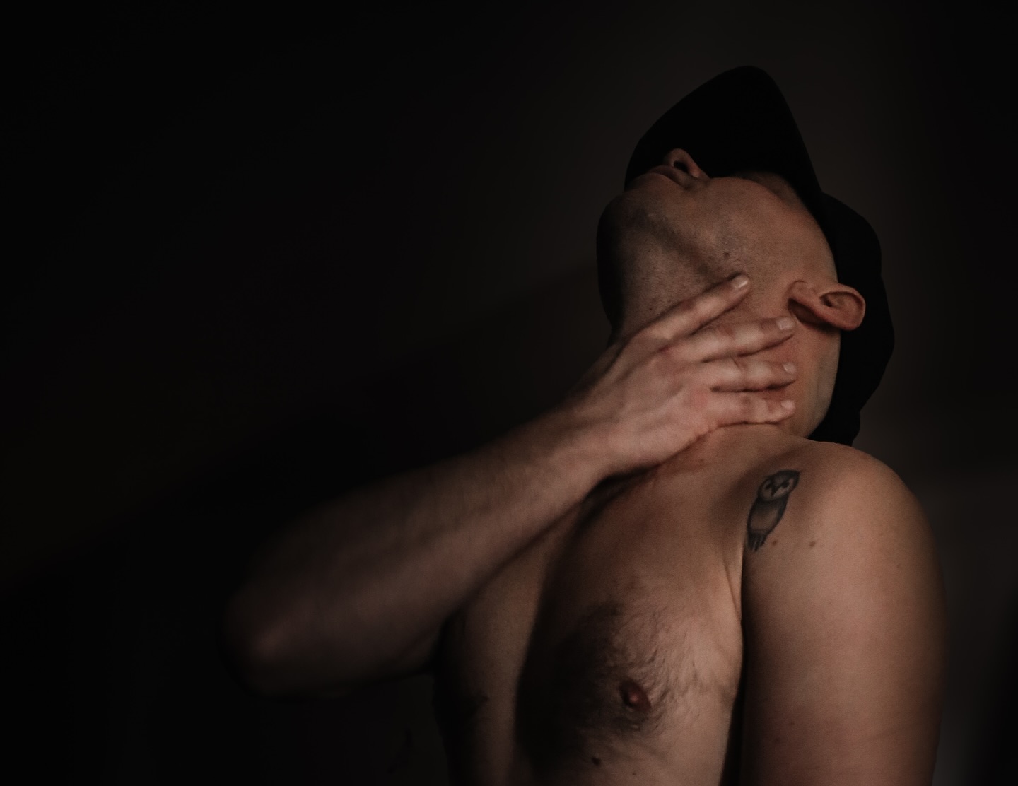 His hand at his throat speaks volumes without a word, a silent yet provocative gesture that both challenges and entices, as if he’s daring you to understand the dark depths of his restraint.
RuggedShadows.com