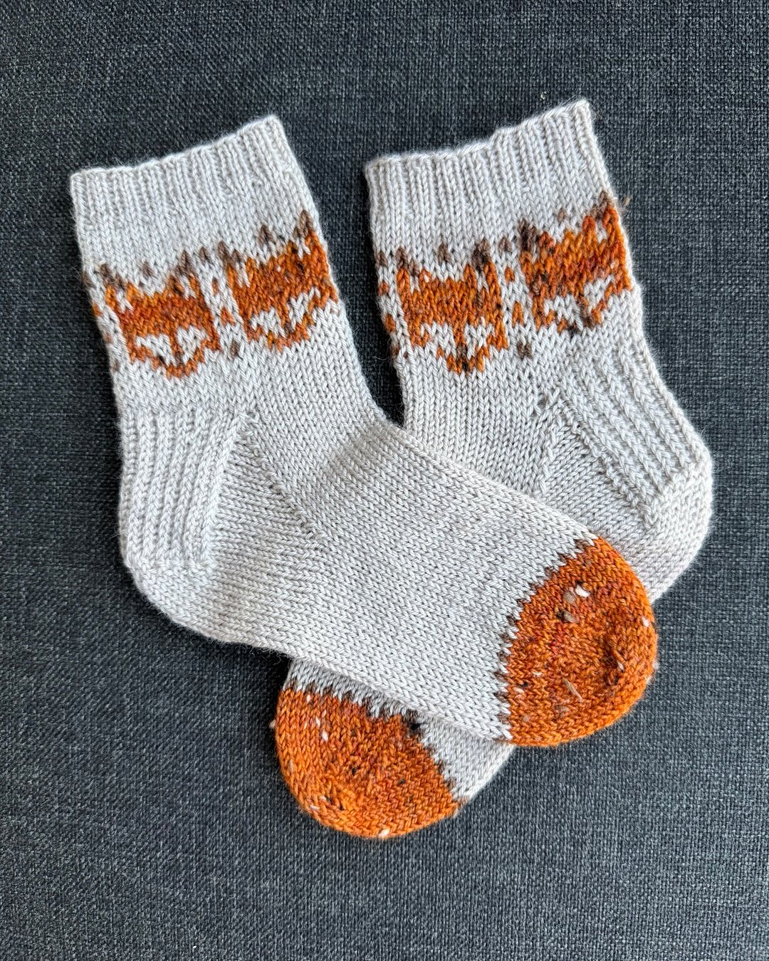 Another little pair of socks for my grandson. He is going to love these. What’s missing you say? Yes I haven’t over stitched the eyes on these cute little fox yet (I’ll get there) You can find these darling fox and so many more great motifs in The Doodle Knit Directory by Jamie Lomax …. Super fun book! I used our Adarah tweed sock in “AUBURN” for the fox and the body is our Adarah BFL sock in “DAD’S OATS”