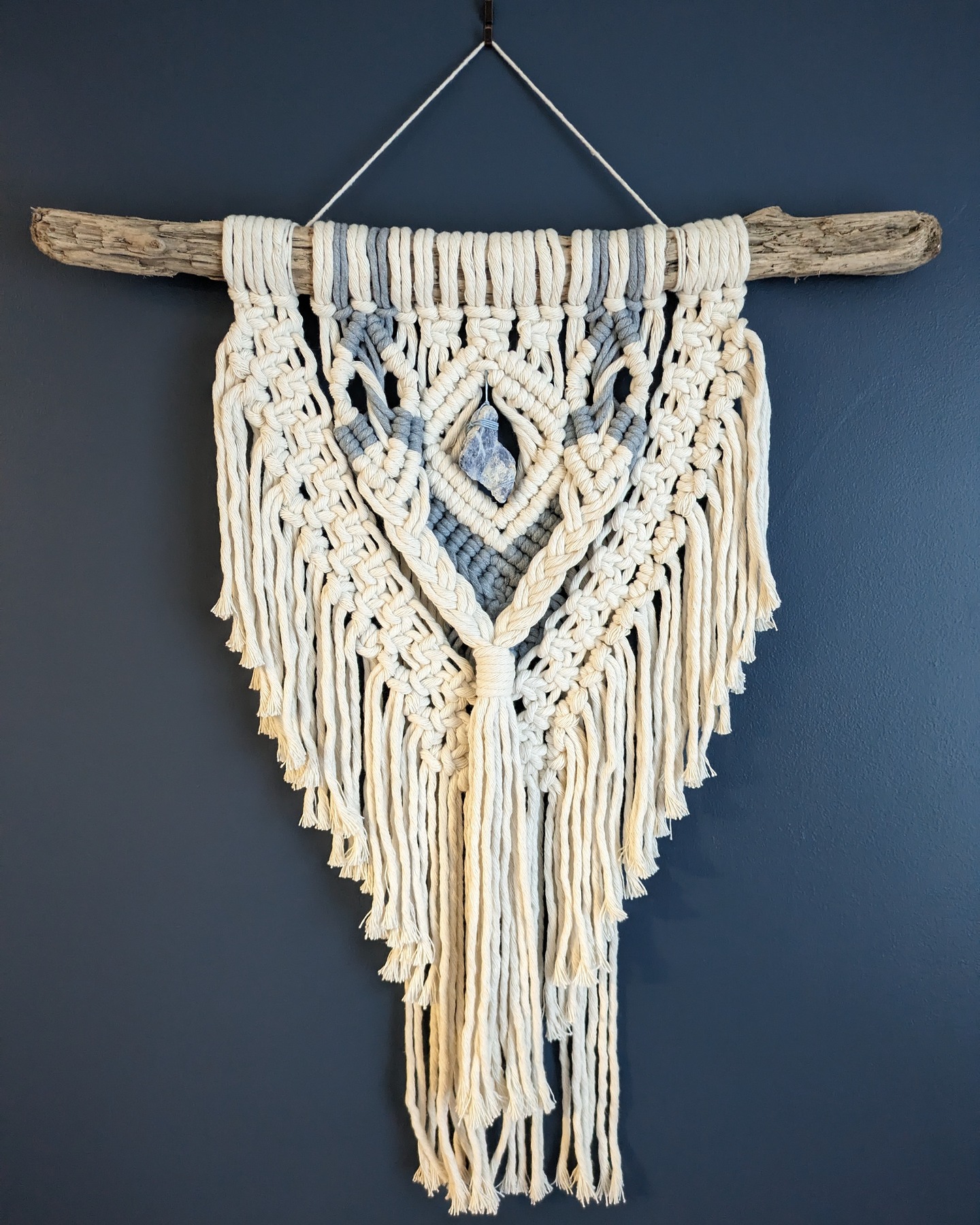 'Blue Quartz' - traditional piece of macrame suspended from a natural driftwood dowel and features a blue rough quartz healing crystal nestled amongst thick and buttery-soft recycled cotton cords in the colour palette of vanilla and china-blue. 360mm x 650mm.
karenmorganart.com
info@karenmorganart.com
#macramé #macramewallhanging #textural #fibreart #interiordecor