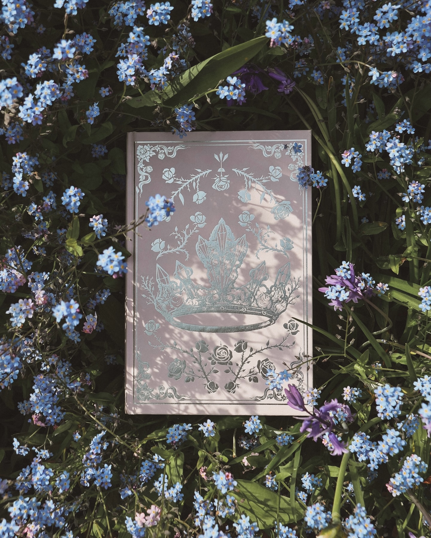 “A forget-me-not, since you always seem to be forgetting who I am.” - Kai Azer, Powerless Trilogy by Lauren Roberts
Just closed the final chapter of this series, and the timing couldn’t feel more perfect, as the landscape surrenders to tangled tides of forget-me-nots - blooming as if the story has spilled into the world.
#PowerlessTrilogy #LaurenRoberts #ForgetMeNots #BookLovers #SpringReads #BookishMoments #InBloom #AprilReads