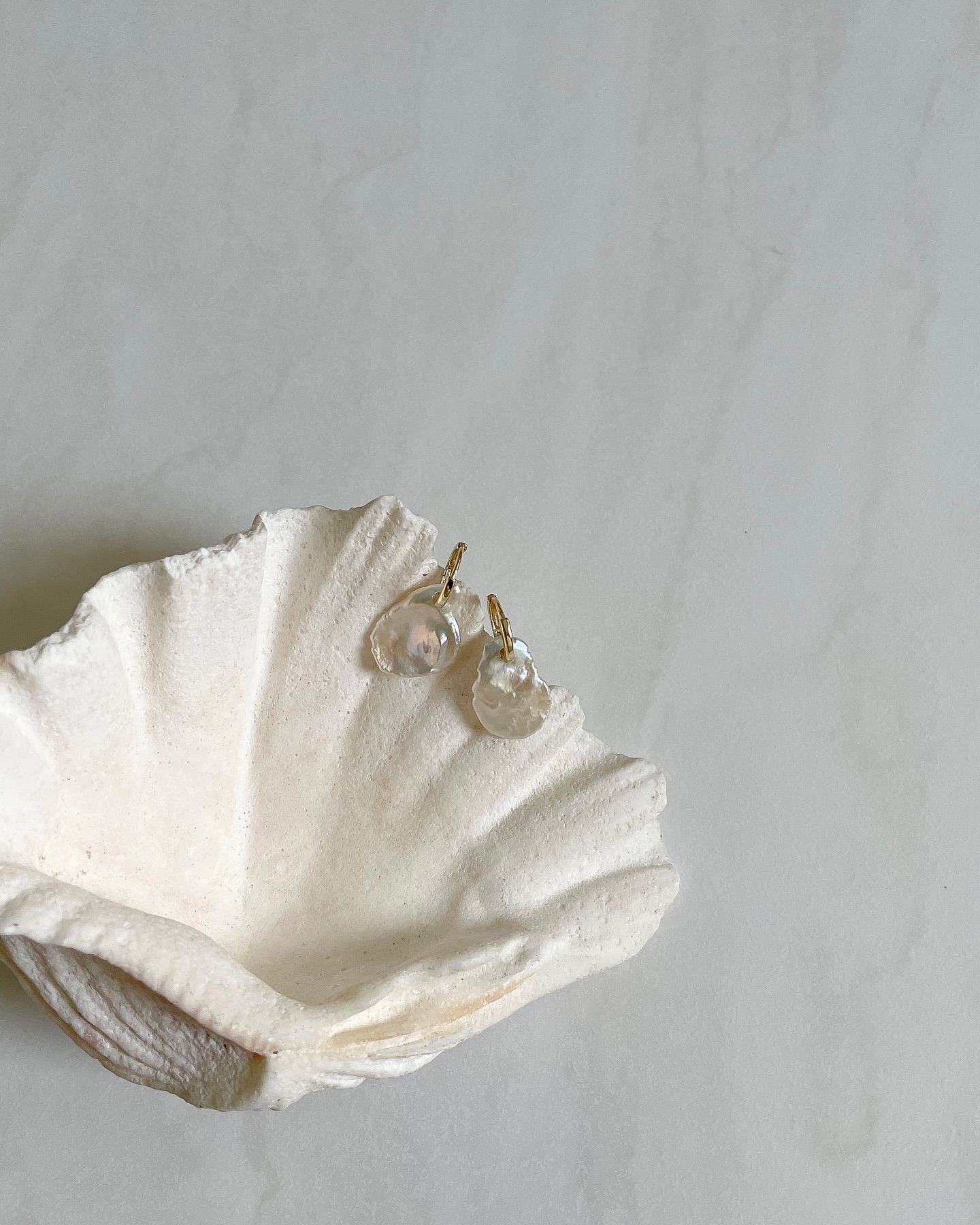 YOURS. 🐚 Limited edition gold-plated 925 sterling silver earrings with real freshwater pearls shaped like petals.