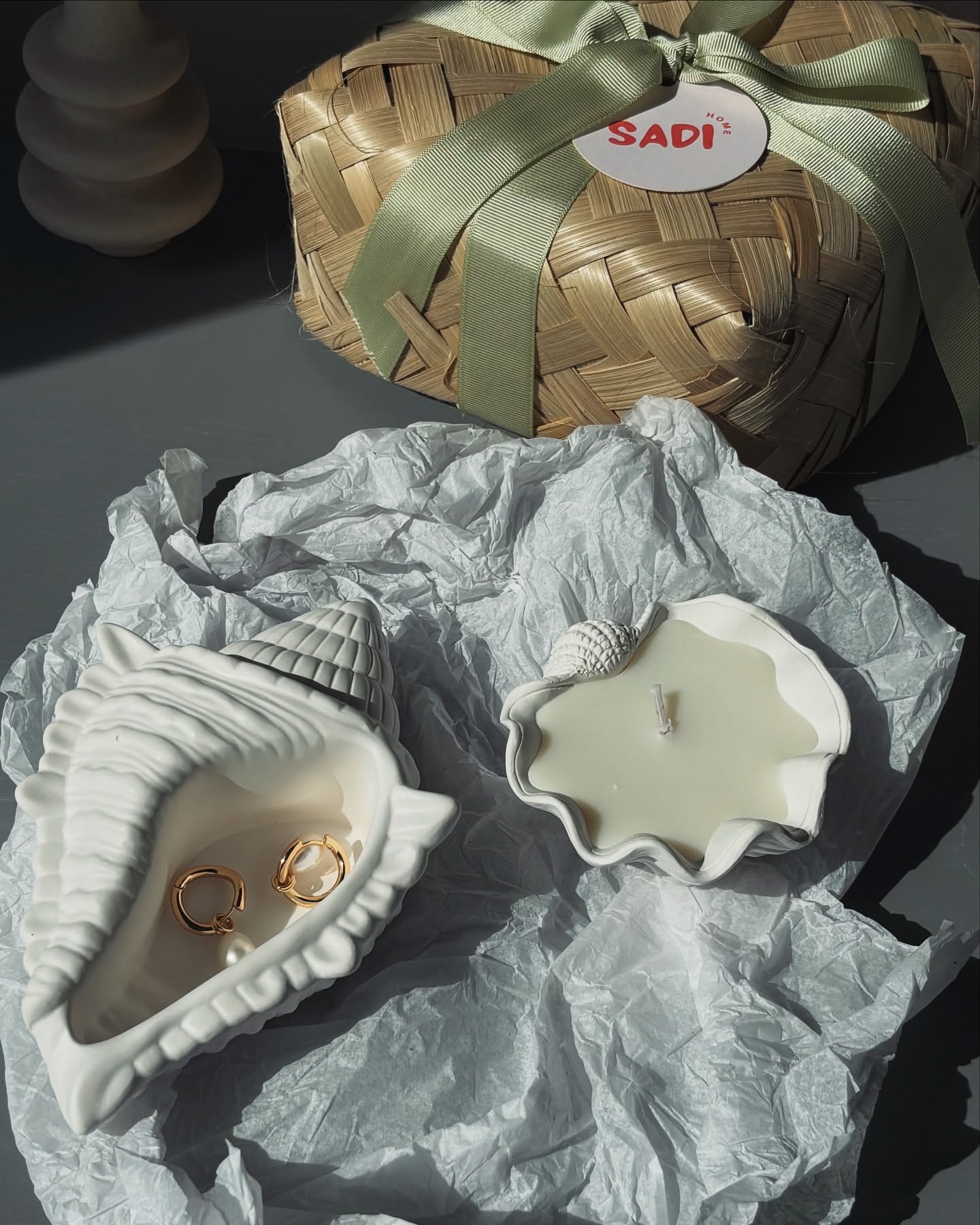 Our ‘little shore things’ gift box - a conch tray and a clam candle, tucked in a handmade rattan box.