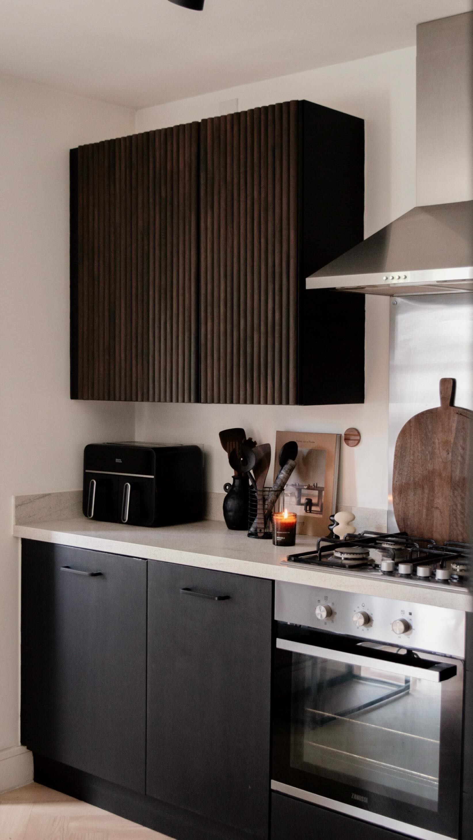 Little impromptu kitchen change 🤎
I had an intrusive thought at like 4am & I couldn’t stop thinking about it 😂 “what would the kitchen cupboards look like stained dark walnut?”
So here it is…. What do you think?
We will also be extending our DIY Limewash from the back dining area wall across the whole of the kitchen. I think this will add even more warmth 🤎
Here’s what was used:
FLUTTO Walnut Ridge Flexible Tambour Wood Panels, available @thewoodveneerhub
We started by painting the top cupboards & doors black, then cut & stuck the panels on with No More Nails.
Lastly, we used @furnitureclinic wood stain in Walnut to give a darker tone
We love the timeless design added to our kitchen space & honestly, these were so easy to install!
Love,
Nicola & Vicki
#thewoodveneerhub #kitchenreveal #kitchendesign #kitchendecor #diykitchen #makeitrustoleum #rustoleum #kitchenrenovation #kitchendesign #kitchendiy #warmminimalism #japandistyle #minimaldecor #japandiinterior #scandihome #interiorideas #wabisabi #slowliving #parisianstyle #beigeaesthetic #interiorandhome #softminimalism #nordichome #nordicminimalism #interior123 #neutraldecor #interior4all #interior4you #parisiandecor #walnutkitchen