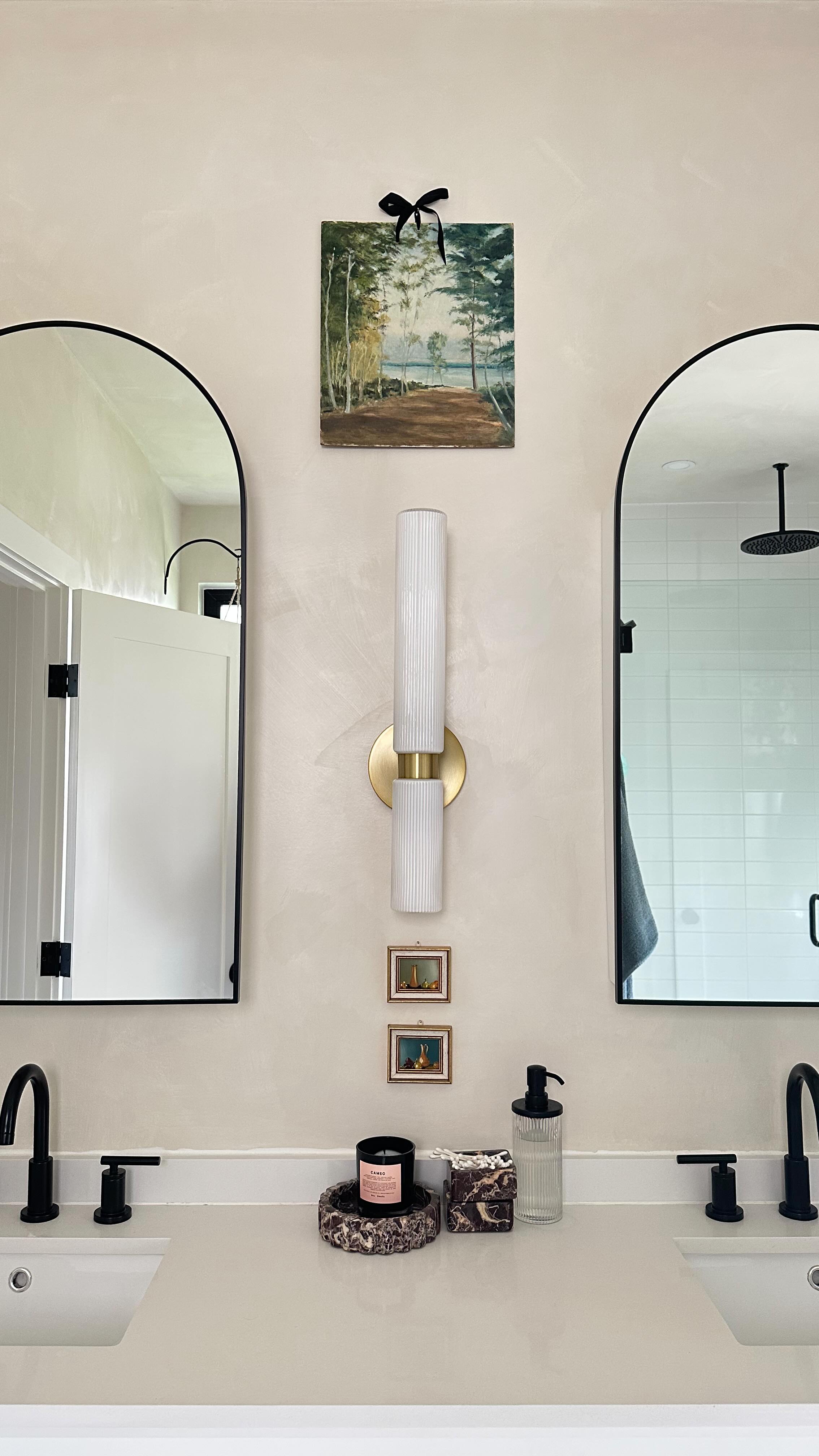 A $10 painting at my local antique dealer turned into a little statement in my bathroom.
Something about the colors and lake subject really, really spoke to me when I saw this little painting last week. I was going to frame it but since it already had a punched hole in the top.. I got some chiffon ribbon and a nail and… done!
I think it looks perfect placed above our medicine cabinets. Art doesn’t have to be expensive to look amazing! Am I right??
#interiordesign #shanalutherinteriors #hudsonvalleyinteriordesign #art
#homedesign