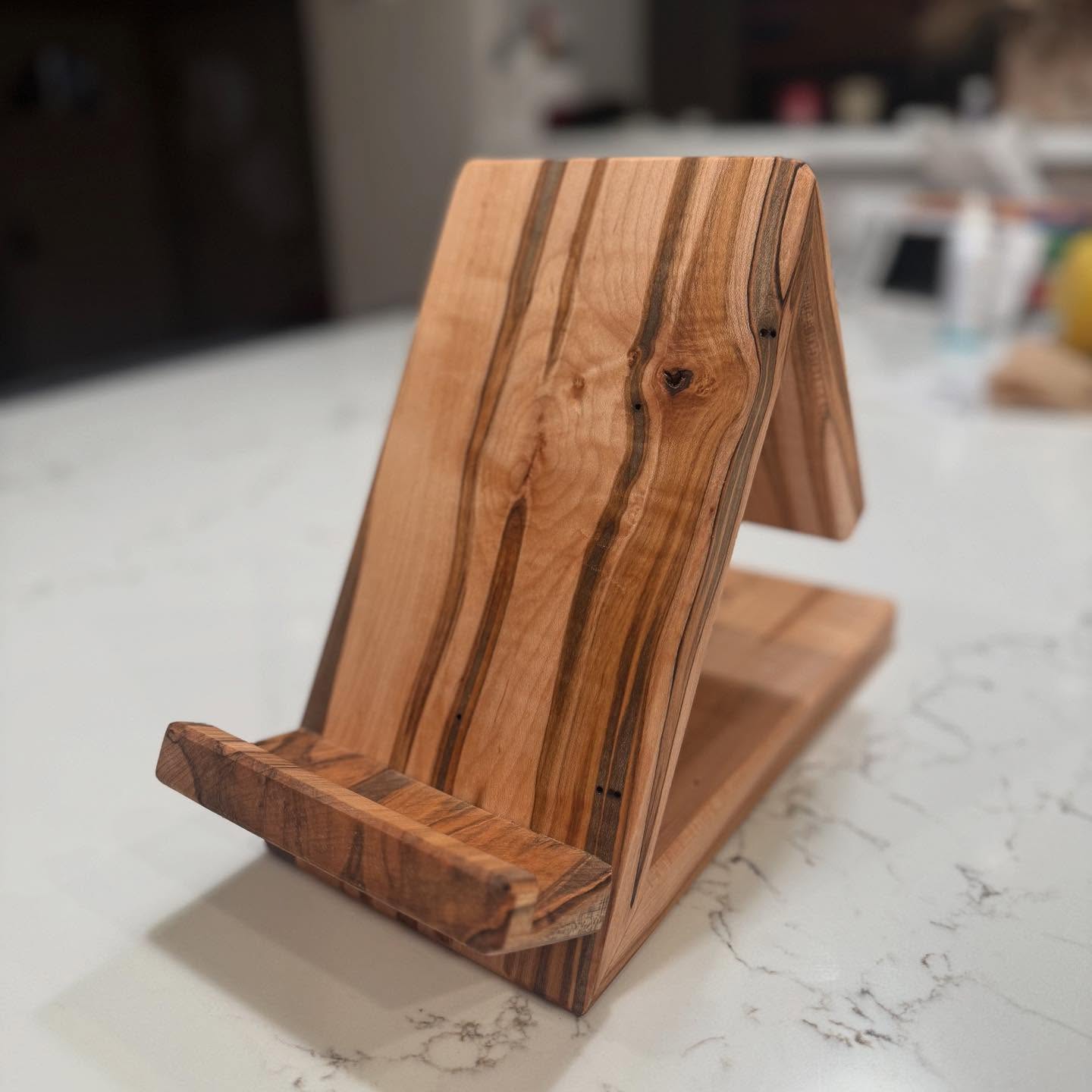 Unveiling the Ambrosia Maple Cookbook Holder
This stunning cookbook holder is crafted from ambrosia maple, featuring unique patterns created by nature itself. Each piece tells its own story through distinctive streaks and figuring that make your kitchen helper one-of-a-kind.
Perfect for keeping your favorite recipes at eye level and protected from spills while you cook. The beautiful wood grain elevates your kitchen decor when not in use.
Handcrafted with care from sustainable sources.
✨ Limited quantities available - made to order!
#homadewoods #AmbrosiaMaple #KitchenEssentials #HandcraftedWithLove #CookbookHolder