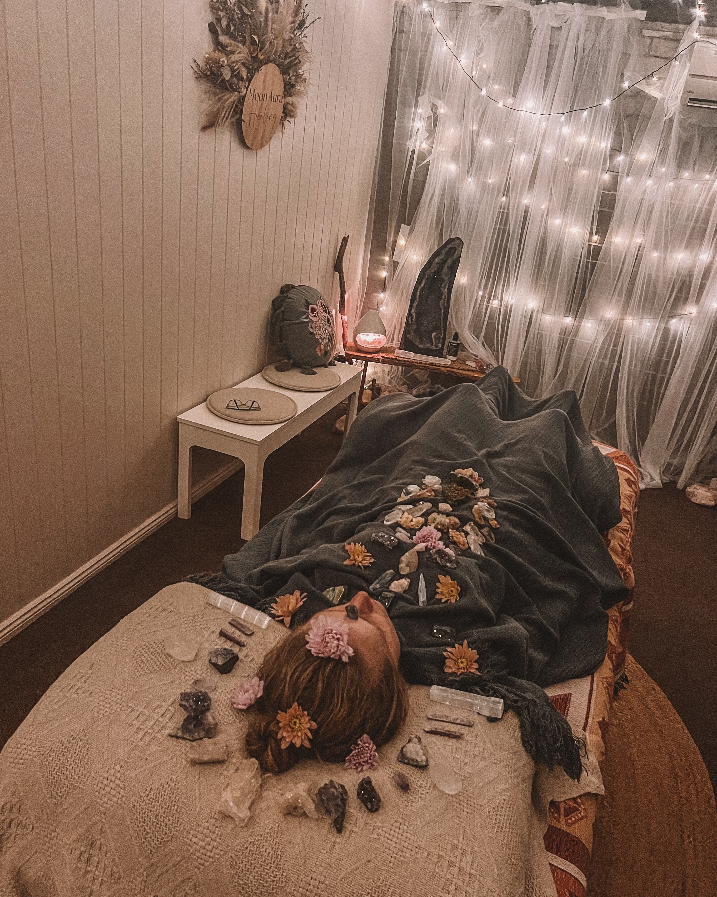 You find yourself in a realm of endless beauty.
A valley of wildflowers, luminous with colour.
The sky above is painted with gentle ribbons of soft gold and blush pink, as if sunrise and sunset have kissed and become one eternal moment.
You feel the earth humming beneath your feet.
You are barefoot — grounded — each step blooming flowers beneath you.
And then you hear it — a voice.
Soft and familiar.
It is the voice of your spirit.
The part of you that never left, only waited.
She whispers:
“Spirit can only give you what you believe you are worthy of. It’s time to believe again.”
You place your hand on your heart.
Feel it.
Steady. Alive. Ready.