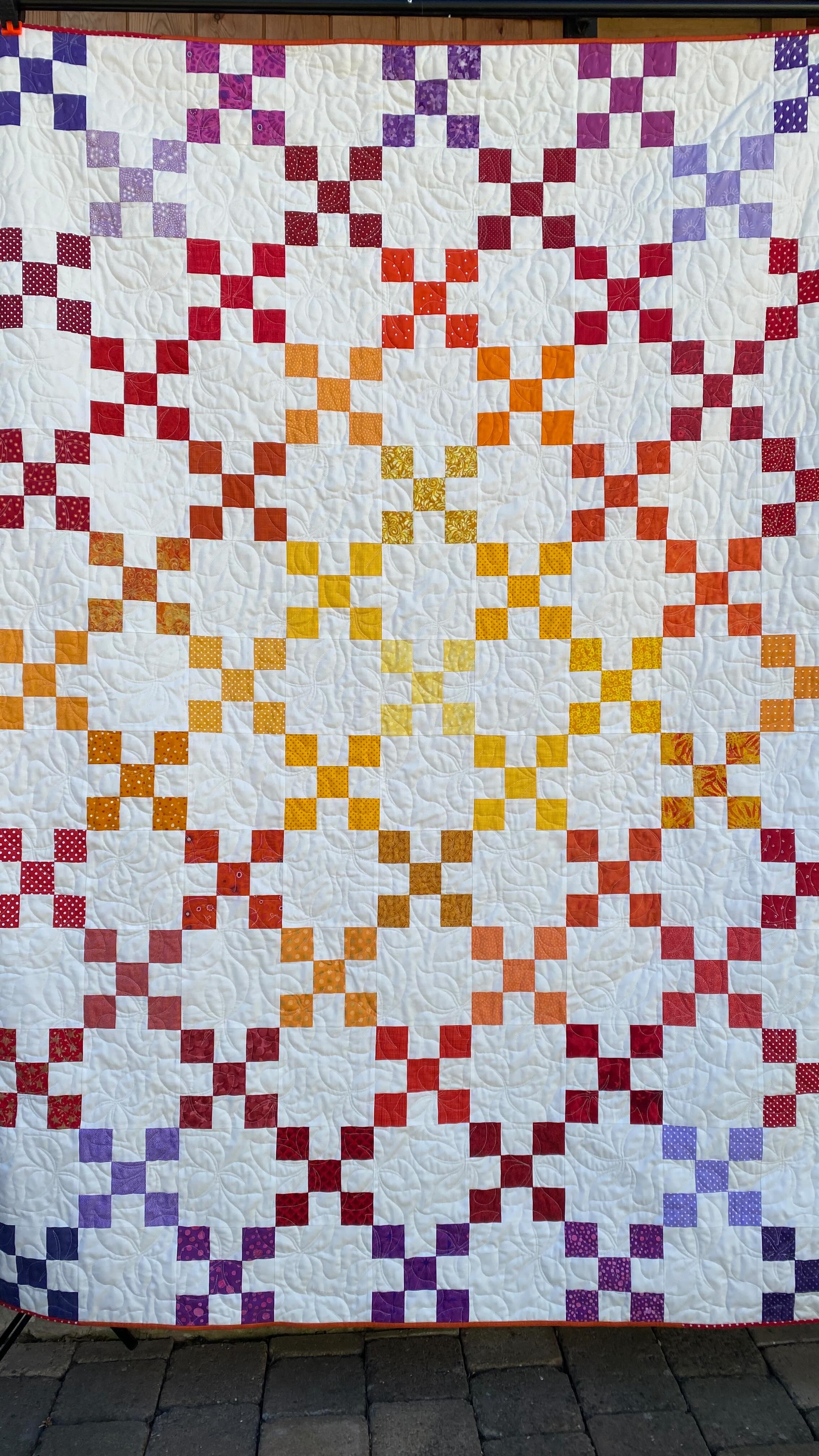 Last month I went on retreat with the @oxfordshiremqg and had such a wonderful time.
The day before it started I had to find something to take with me and whilst I have many WIPs on the go I wanted something that I didn’t have to think about. So I started cutting …
I have never cut a whole quilt out in advance before and never in a day. I chose an Irish Chain design and wanted to use up some scraps. The original idea was just red and off white but I soon ran out of red scraps! It therefore became a rainbow - whilst I don’t think the colour scheme shows off the Irish Chain design that well I still like the finished quilt.
It was almost pieced whilst on retreat but to keep the colour gradations I decided to swap out a colour of the fabrics so I had to wait until I was home.
It was then promptly loaded onto my frame and quilted. My frame was reduced down to 8ft late last year so this was a real test. This quilt was 76” long and I loaded it horizontally and it just about fit!
Scrappy binding completed the quilt and I actually enjoyed finishing it off by hand.
Fabrics: scraps from stash
Background: @dashwoodstudio Pop Solids in Ivory
Pieced: on my @janomeuk 9450
Quilted: on my @handiquilter Amara
Thread: @habanddash Glide in Linen
#scrappyquilt #irishchainquilt #rainbowquilt #quiltingcommunity #cutandalterfinish2025 #longarmquilting #handiquilter #janomeuk #janomemakes