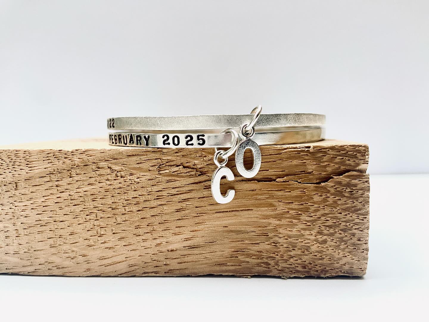 A slight modification to our simple Sterling Silver text bangle...
As well as your bangle being personalised with your own words, this one also carries a single Sterling Silver initial charm!
There is plenty room for your favourite lyrics, your childrens names, or your own life mantra.
We don’t engrave our jewellery, we hand stamp each letter individually - it’s way cooler, and gives your bangle extra personality.
There is the option of two finishes on this design - left smooth, and polished to a beautiful shine, or a brushed, frosty texture. Nikki adds an oxidising solution to the stamped letters to darken them and really make the words POP!
Custom made, beautiful jewellery- by @magicinthegrass