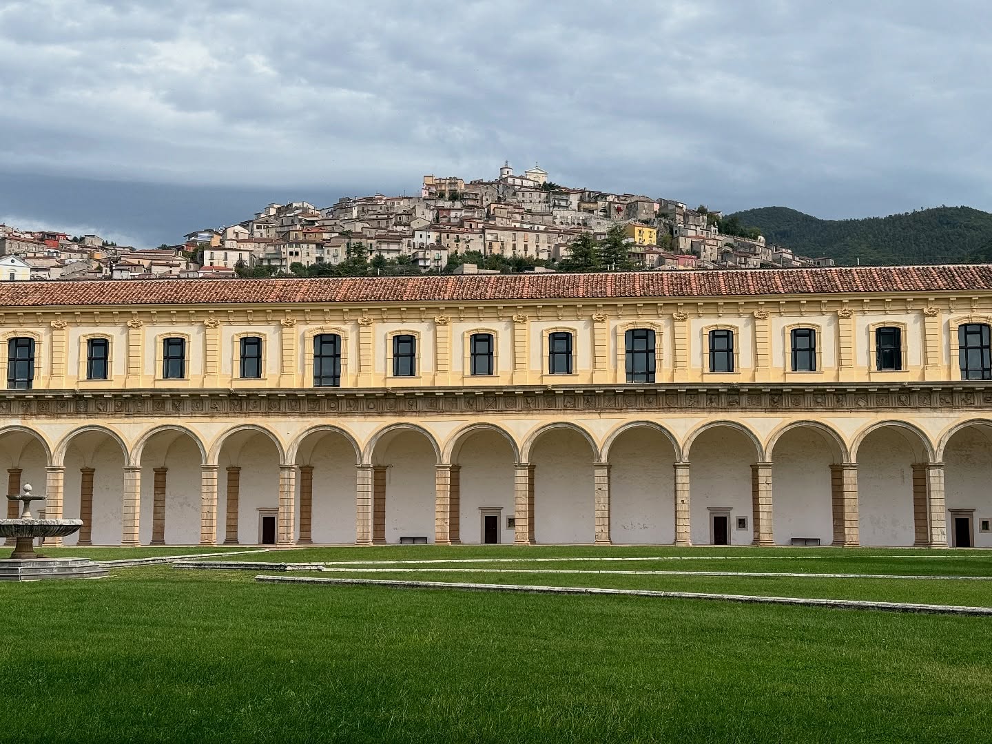 It may seem like strange advice to travel to the middle-of-nowhere-southern Italy to see a staircase
Why not stay in Rome and see the Spanish steps? Especially since there’s nothing else on social media about this staircase and only one guidebook mentions the place: Certosa di Padula—largest Carthusian monastery in the world, built in 1306.
Ok fine, who cares?
But you should go.
The peace and quiet settles over you as you approach the entrance and your shoulders slowly drop. Then you start walking and the scale of the place starts to inspire awe. A cloister that is 12,000 meters — the size of two football fields and the hilltop village of Padula visible from inside, like a crown.
Then there’s the kitchen, bigger than the kitchen of a giant hotel because it fed the hundreds of monks who once lived here, all in a constant state of meditation. That peaceful energy still permeates, even though the monks are long gone.
And then—that staircase, floating in space, a place where you could sketch if you have pen and paper with you, or just marvel at it.
I tried to capture it for Instagram but failed miserably because this place wasn’t made to be photographed. It was made to be felt. It’s an experience, not a souvenir.
And so there are few tourists. No crowds. Just beauty that inspires awe and wonder and softens your heart a little bit even if you can’t explain why.
That’s why places like this are the focus of my newsletter and podcast. Not just pasta and spritzes and stereotypes that the algorithms prioritize. I am dedicated to being the place on the Internet for you to find inspiration and information you can use to plan a trip to Italy that is meaningful. That helps you avoid the theme-park-Italy that diminishes Florence and Venice and other ultra-photogenic places.
If you’re planning a trip, you can feel free to skip the obvious because every corner of Italy has something like that staircase. This is where you can find them. #italy #italytravel #italytrip #offthebeatenpath #italian