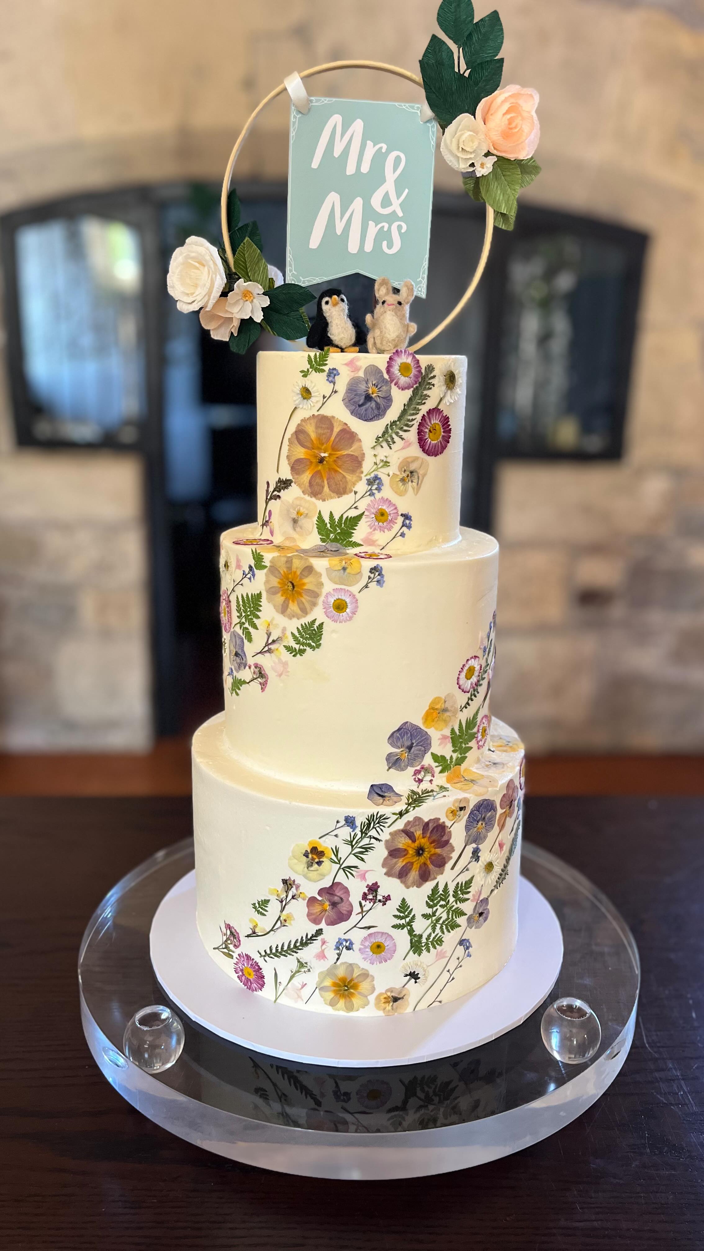 Just married at the magical @thornburycastle on 29.04.25 ✨
Nicola & Connah’s cake was a dream—adorned with delicate edible pressed flowers from @awesidefarm spiraling up to the sweetest personal touch: a penguin and bunny topper, just like them—unique and full of love.
.
.
.
#ThornburyCastleWedding #PressedFlowerCake #WhimsicalWedding #JustMarried #cakedesign #cakecakecake #buttercreamcake #bakersofinstagram #weddingcakes #weddingcakeideas