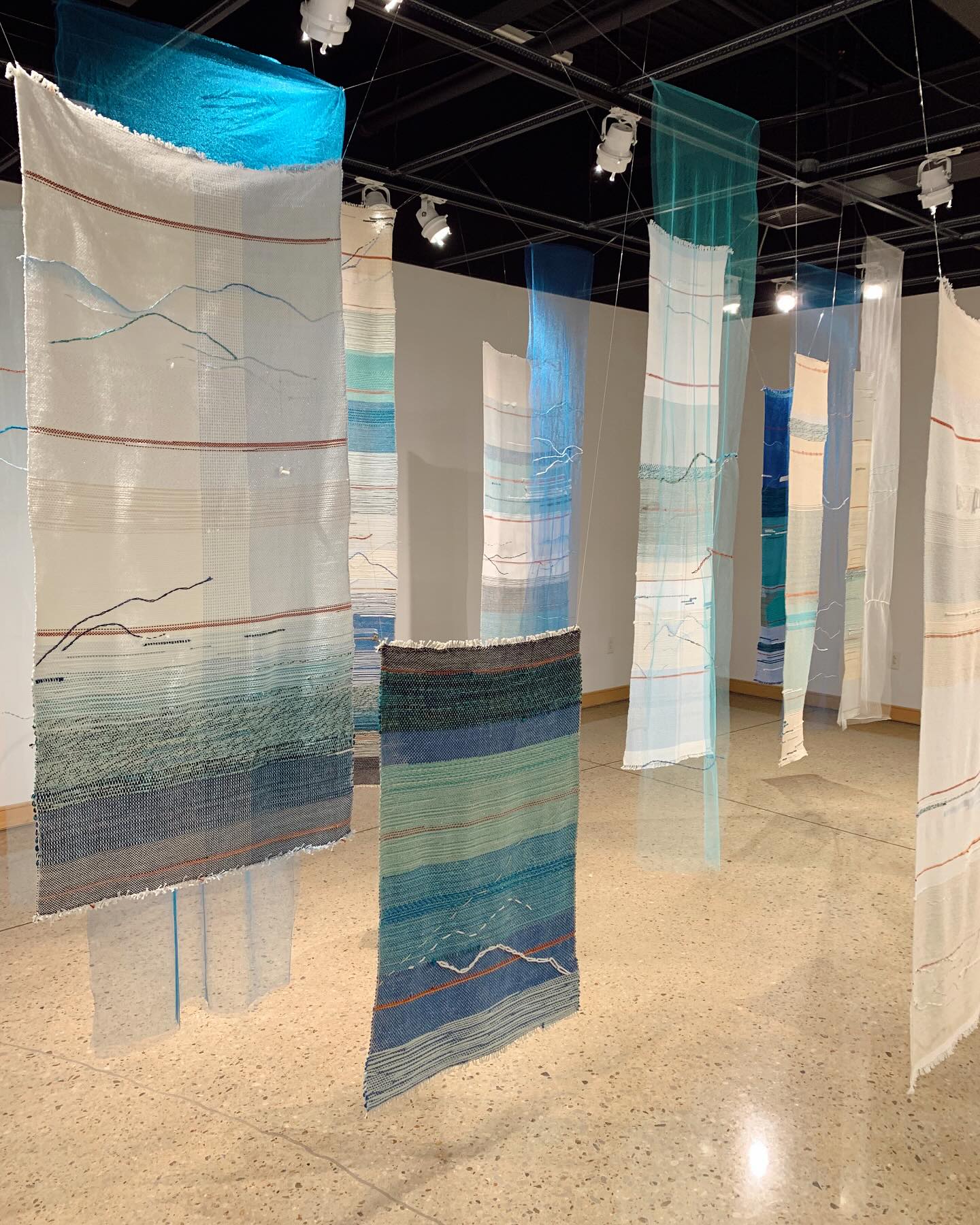 Flow, 2019.
My favorite aspect of weaving is how meditative it can be. In “Flow”, I started the journey of healing from many things… unmet expectations, not feeling like I was enough, essentially being my own worst enemy. Each red line indicates an hour of time spent in reflection and thankfulness, replacing those feelings of doubt. The room ended up feeling peaceful and tranquil, starting off this journey kind of safely and slowly. Someone once told me, “It’s amazing how much people come to life when they feel safe.” And I think that’s why my work has continued to get brighter and brighter. This work is for anyone who can relate in some way 💙