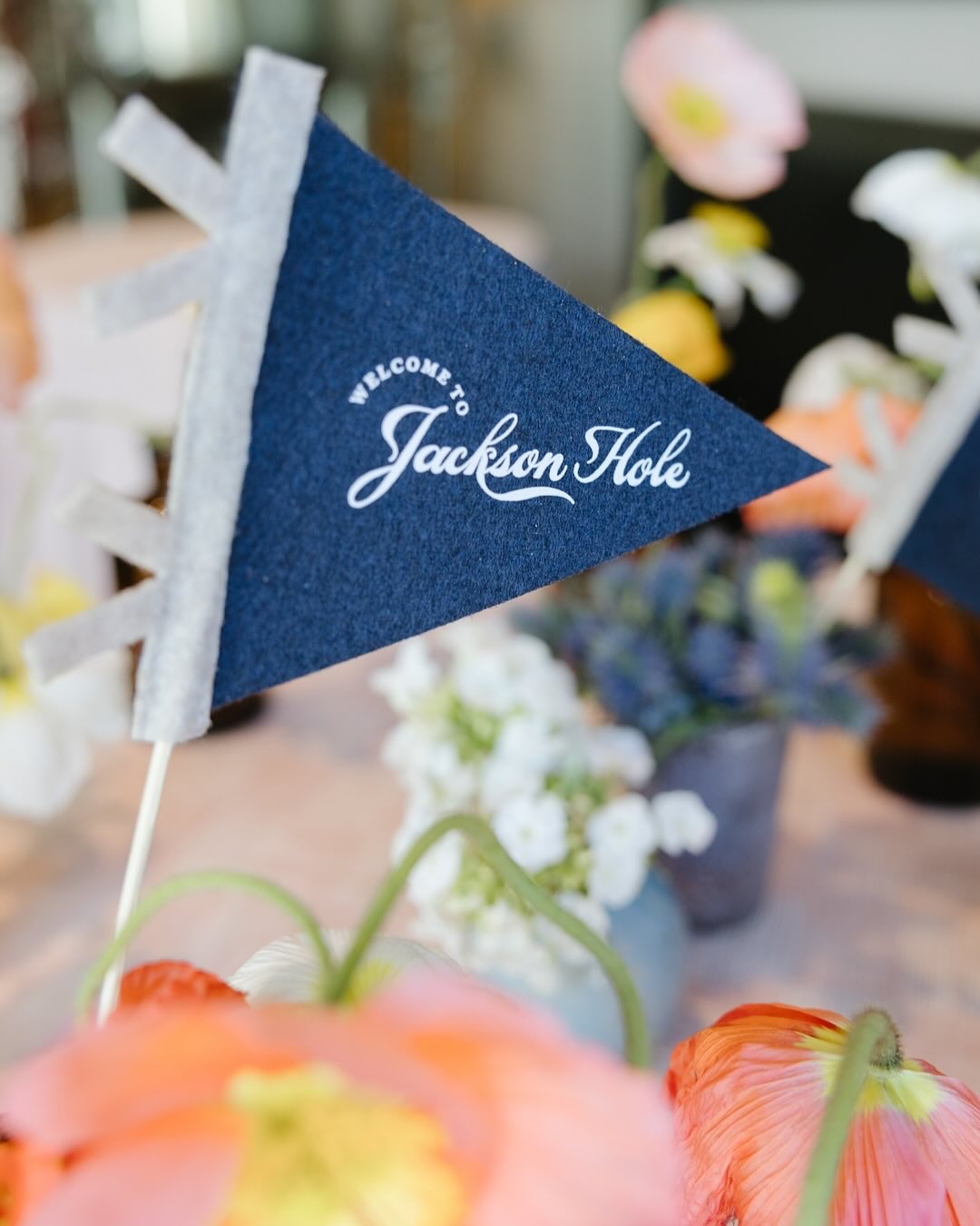 Design a script that evokes summer camp vibes. I never got to go as a kid but I need this on a t-shirt.
for @xowyopaper
Repost from @xowyopaper
•
Mini flags, major impact. For Jami and Ian’s welcome party, we created custom felt flags to tuck into floral arrangements, each one a playful nod to their story: Jackson Hole, Welcome to Wyoming, and The Madbergs (their sweet mashup nickname for their blended family). The goal? Channel summer camp energy from the very first gathering.
Design, florals: @magnoliaranchevents
Tabletop: @xowyopaper
Paper: @objetwest
Photography: @roslyn.smithers
Venue: @diamondcrossranch @diamondcrossweddings