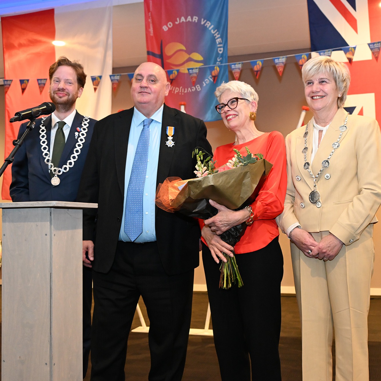 The Taxi Charity for Military Veterans is proud to announce that our vice president, Dick Goodwin, has been awarded the distinguished title of Knight in the Order of Orange-Nassau by His Majesty King Willem-Alexander of the Netherlands.
This royal honour, conferred on Dutch Liberation Day in Wageningen, is especially meaningful as it recognises the contribution of a British citizen to Dutch society and international friendship. The award was jointly presented by the Mayor of Wageningen, Floor Vermeulen, who gave a speech, and the Mayor of Renkum, Agnes Schaap, who had the honour of presenting and pinning the insignia.
Dick has been a dedicated volunteer with the Taxi Charity since 2004, serving as a linchpin in organising memorial visits and commemorative events for British veterans in the UK, the Netherlands, Normandy and across Europe. His tireless work ensures that veterans can return to the places where they served, to honour fallen comrades and share their stories with new generations.
Dick has played a leading role in fostering connections between British veterans and Dutch communities, especially young people. He has facilitated meetings, encouraged discussions and strengthened the bonds between Dutch students and veterans, thus securing the proverbial bridge to the future. His efforts to involve veterans in events including Dutch Liberation, the Airborne March and Market Garden commemorations have built lasting friendships and deepened mutual understanding. These emotional reunions are cherished not only by veterans but also by the Dutch people.
Colin Mills, London cab driver and chairman of the Taxi Charity, said: “We are absolutely thrilled that Dick has been awarded the title of Knight in the Order of Orange-Nassau. His dedication to the veterans we support, and to preserving the bonds between the UK and the Netherlands, is extraordinary. Dick embodies everything the Taxi Charity stands for - service, compassion and remembrance - and this honour is a fitting tribute to the many years he has devoted to ensuring our veterans are celebrated, supported, and never forgotten.”
Photo: Floor Vermuelen, Dick and Susy Goodwin, and Agnes Schaap