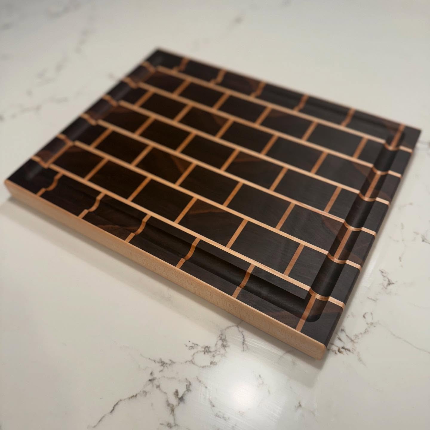 Just finished this walnut and maple end grain cutting board and boy is it a beaut 😍
At 14” x 10.75” x 1.125” this is the perfect size to upgrade the style of any kitchen.
Now for sale on my website.
#homadewoods #woodworking #cuttingboard #smallbusiness