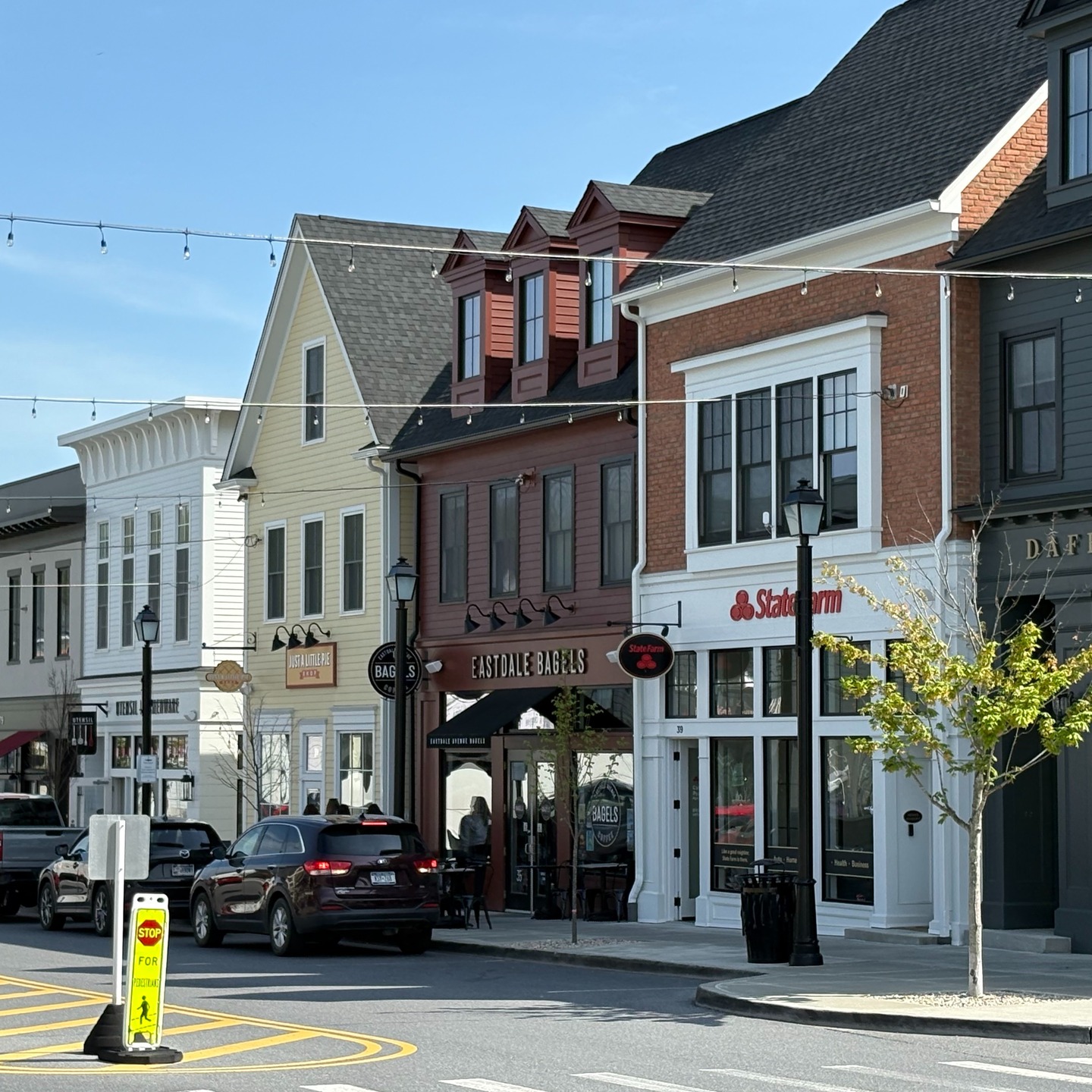 Earlier this month, Elizabeth and Eric joined other @town_builders members at the Spring Roundtable in Poughkeepsie, NY to gather, learn from each other’s work, and get to know the new town center of @eastdalevillage, located on the outskirts of Poughkeepsie in the Hudson Valley.
Eastdale Village prioritizes human-scale design, walkability, public spaces, and mixed-use development balancing use, function, and a decent amount of cute.
Key lessons learned:
1. This project was a good example of residential being a bigger priority as a long term hold.
2. Project partners developed really creative strategies to build the commercial spaces incrementally for small business owner occupants.
3. A key success of the project is due to the significant amount of time project partners spent discovering and building relationships with small businesses that would make for a great community. The partnerships were established from the start of the project and continue to present day.
4. The commercial buildings typically have three units of rental housing upstairs, owned by the small business owner, managed by the residential property managers.
Project partners include @kirchhoff_companies @unionstudioarch