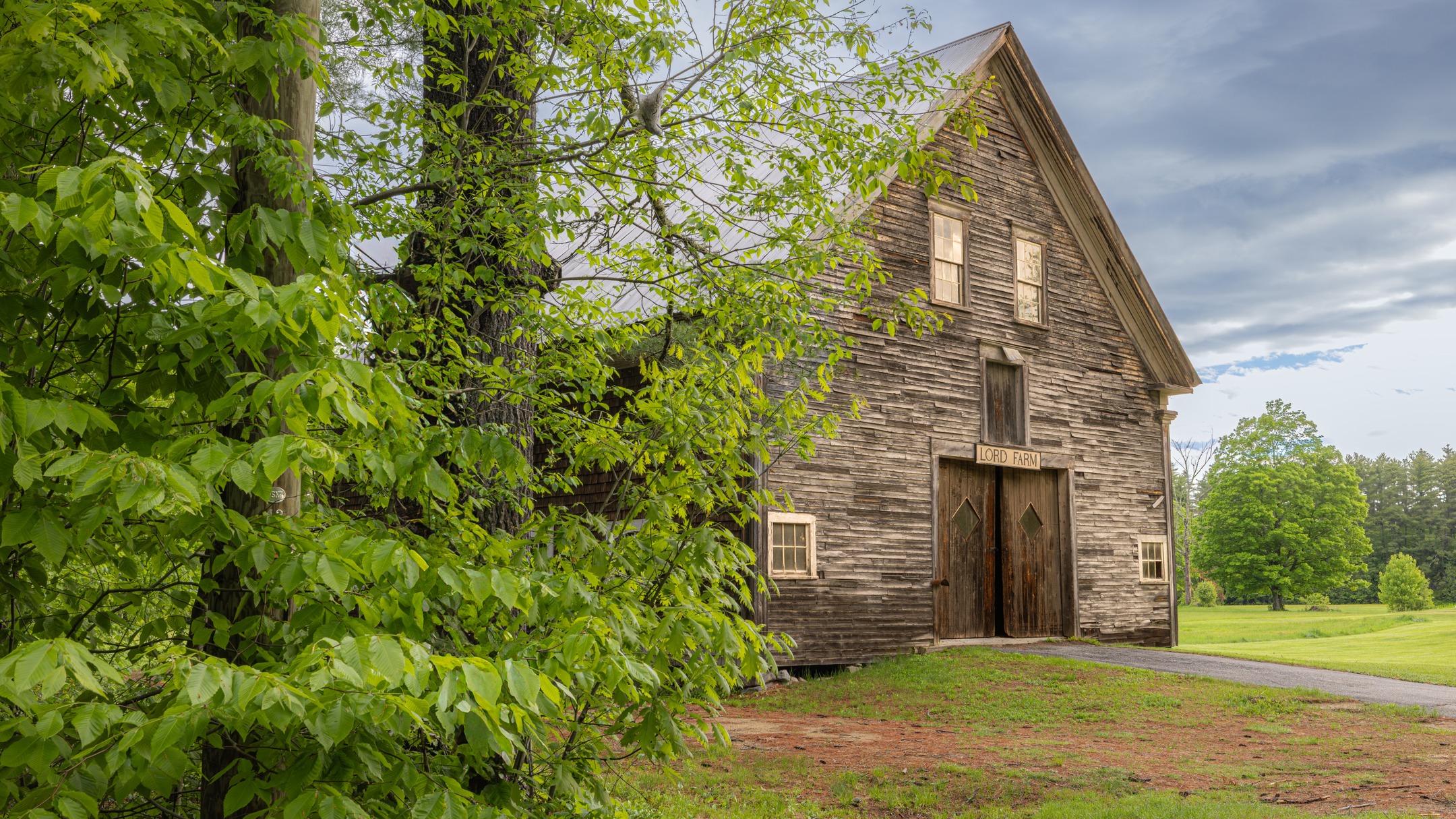 Sunday Morning, Lord Farm, Whittier, NH
I set out with a plan—to capture the historic Whittier Covered Bridge in the soft light of morning—but the world had other ideas. As I wandered, my eyes landed on this weathered old barn, standing quietly in the landscape, steeped in history and character. Its aged wood and simple architecture spoke of endurance, of stories whispered through seasons, of a place that had seen many mornings like this one.
I am proud of myself for staying open—to the unexpected, to the quiet beauty that often hides in plain sight. This image is a reminder that sometimes, the most compelling moments aren’t the ones we set out to find, but the ones that find us.