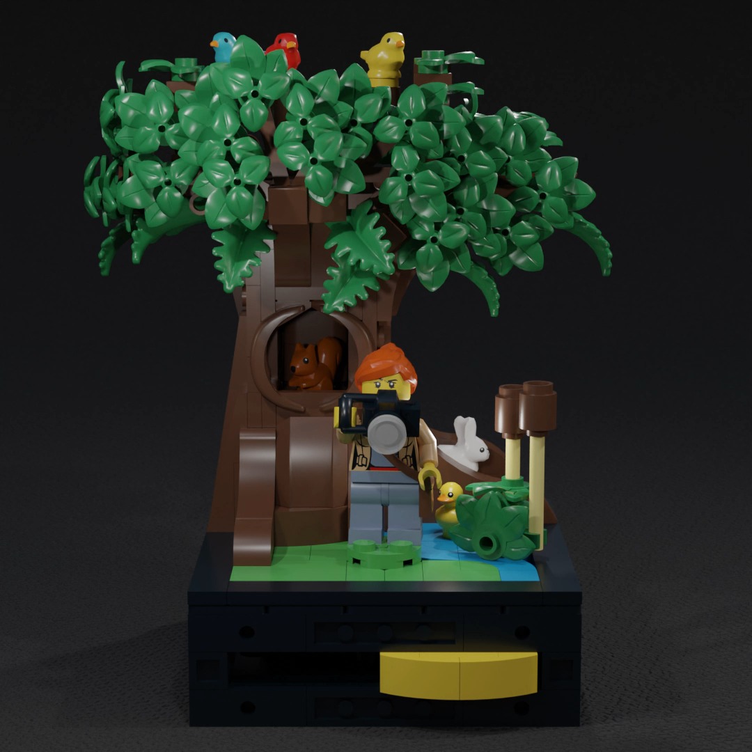My goal in this project was to design a compact LEGO set based on various small-scale mechanisms activated by a single actuator, intended to serve as a gift with purchase. After keeping this goal in the back of my mind for a few days, I got the idea for this set during a walk through the forest, where we found many tracks and signs of animals but didn’t encounter a single one. I figured I could replicate this experience by showcasing the different ways an animal can appear and disappear based on the position of a minifigure.
I chose to use a wildlife photographer because, even though I prefer to enjoy the moment without taking a photo, I realized it clearly conveys the character’s goal within the scene. Although I wanted a small forest scene, I decided to include a pond with wilder vegetation to help illustrate that it is a wildlife scene rather than one in a backyard.
One of the bigger challenges was working on such a small scale, as LEGO Technic has many pieces meant to complement each other that are too large for a 10-stud-wide LEGO set. (Seriously, 7.8 cm is sooo tiny!) In the next design iteration, I would fine-tune the mechanism to improve both its fluidity and the strength of its connections.