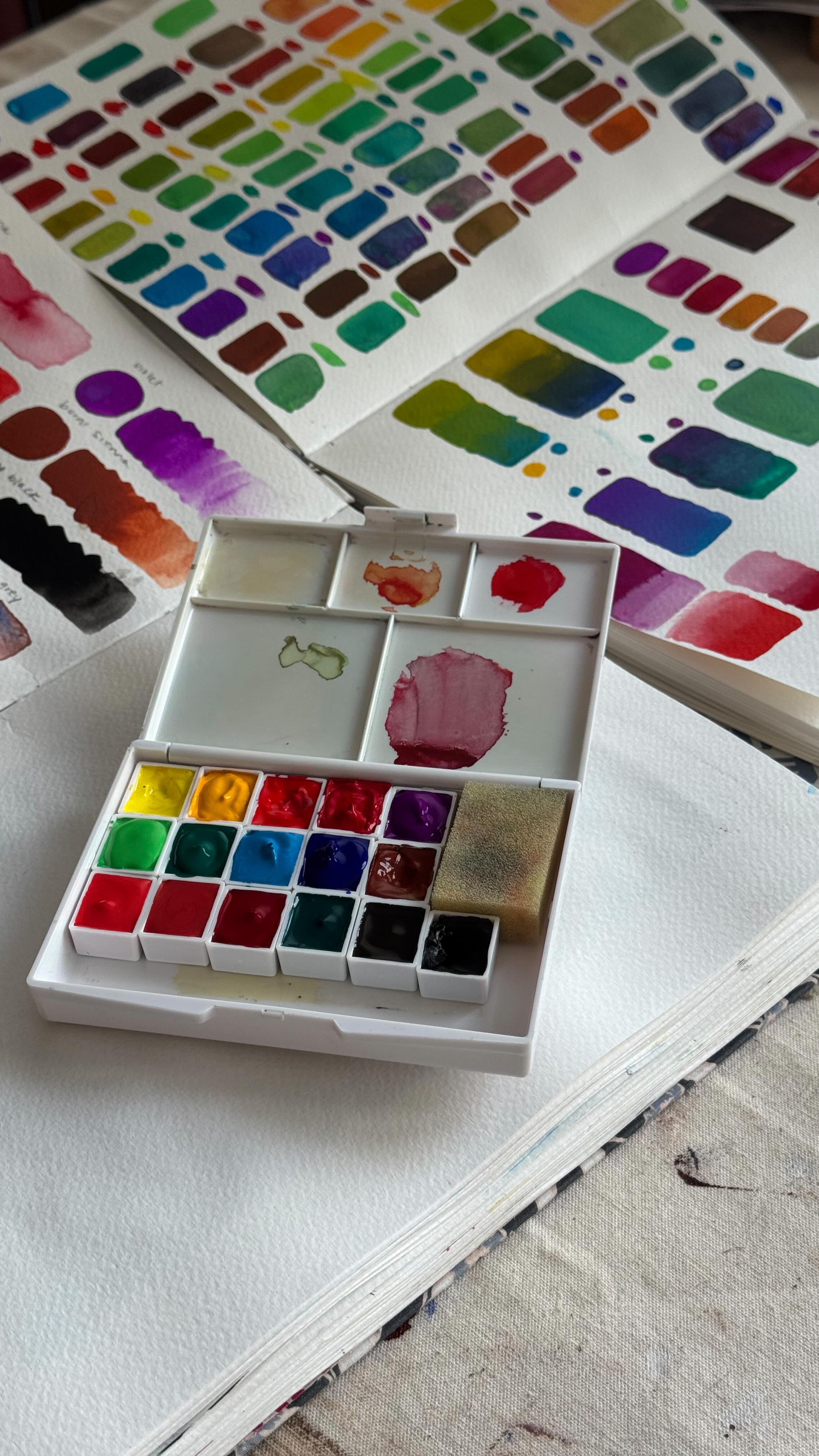 Relaxing weekend spent paint pan filling and swatching.
#artistpalette #paintswatches #fillyourcup